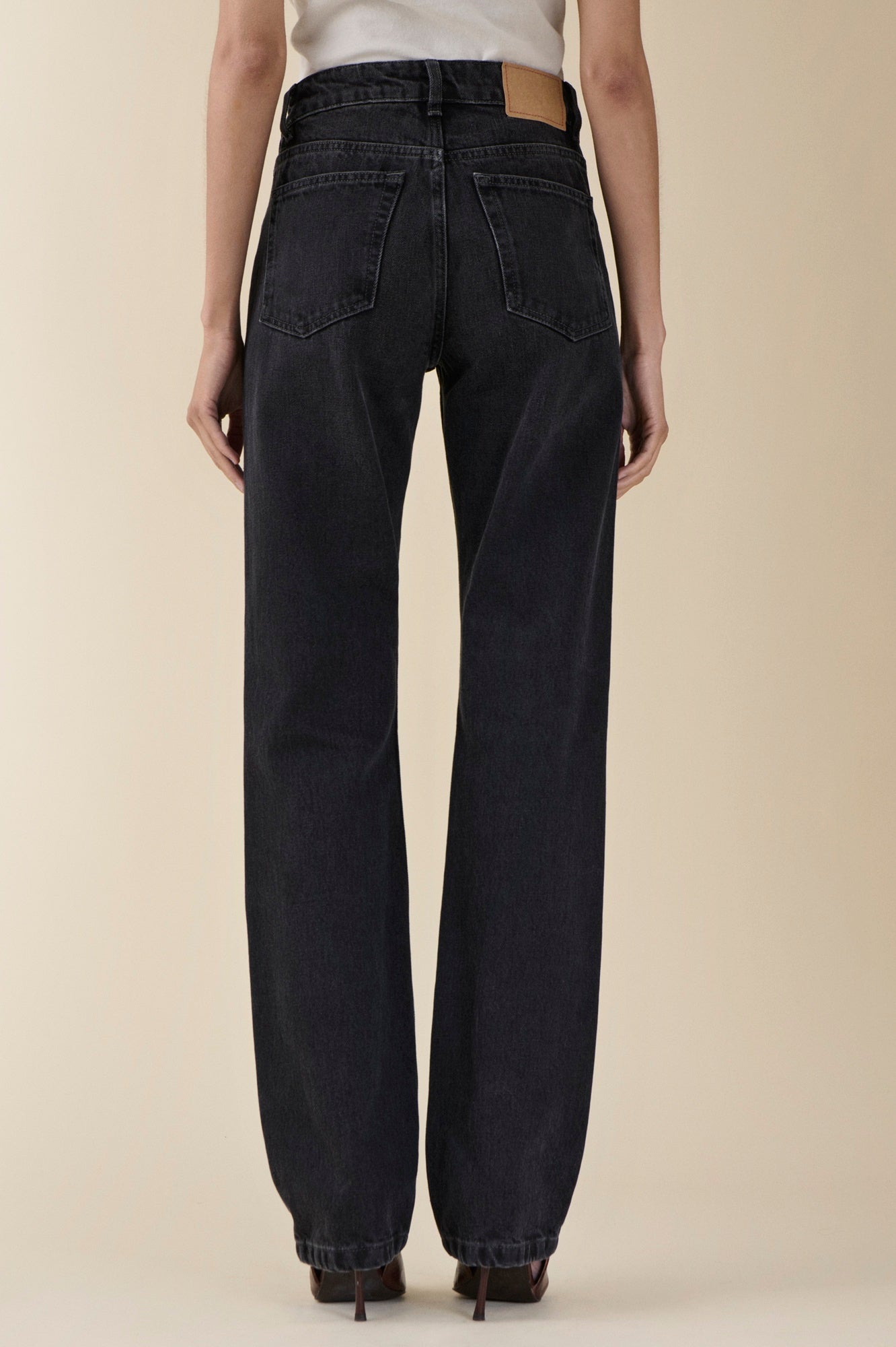 back image of a woman wearing the Jeanerica Sisli Jeans in Gesso Black