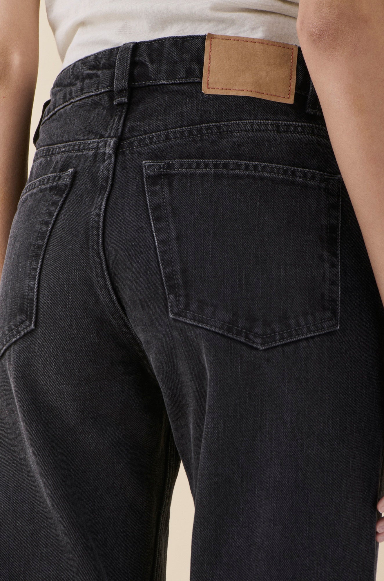 back image of a model wearing the Jeanerica Sisli Jeans in Gesso Black