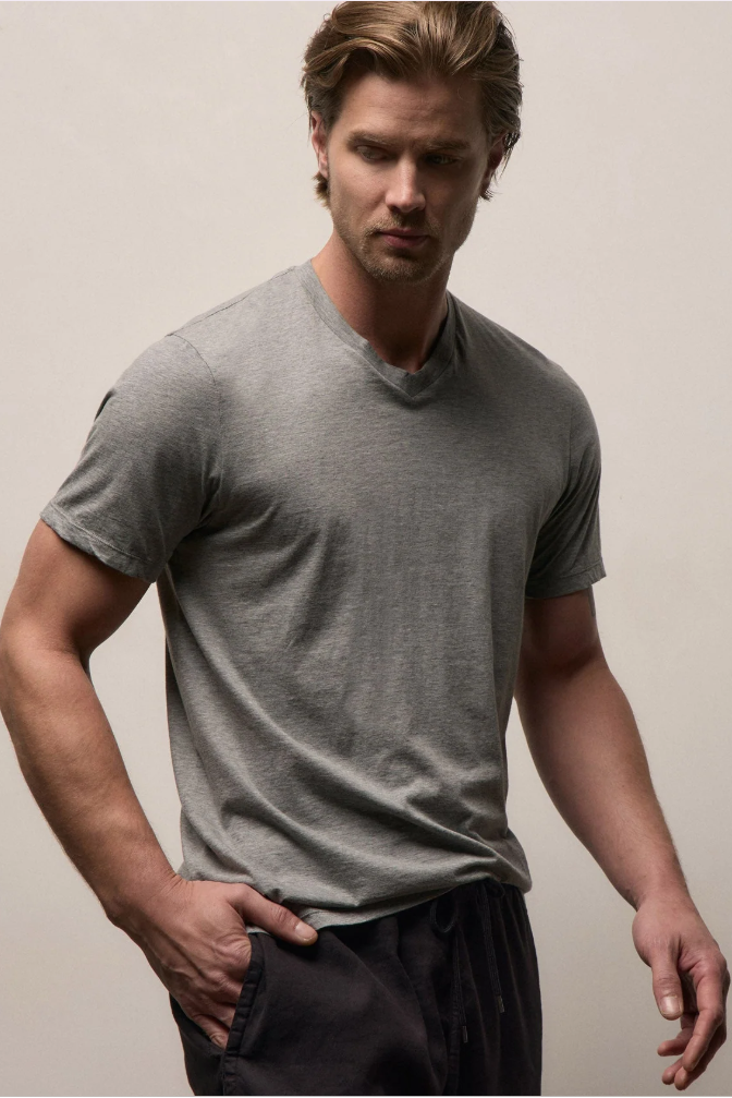 Man wearing a gray t-shirt against a plain background