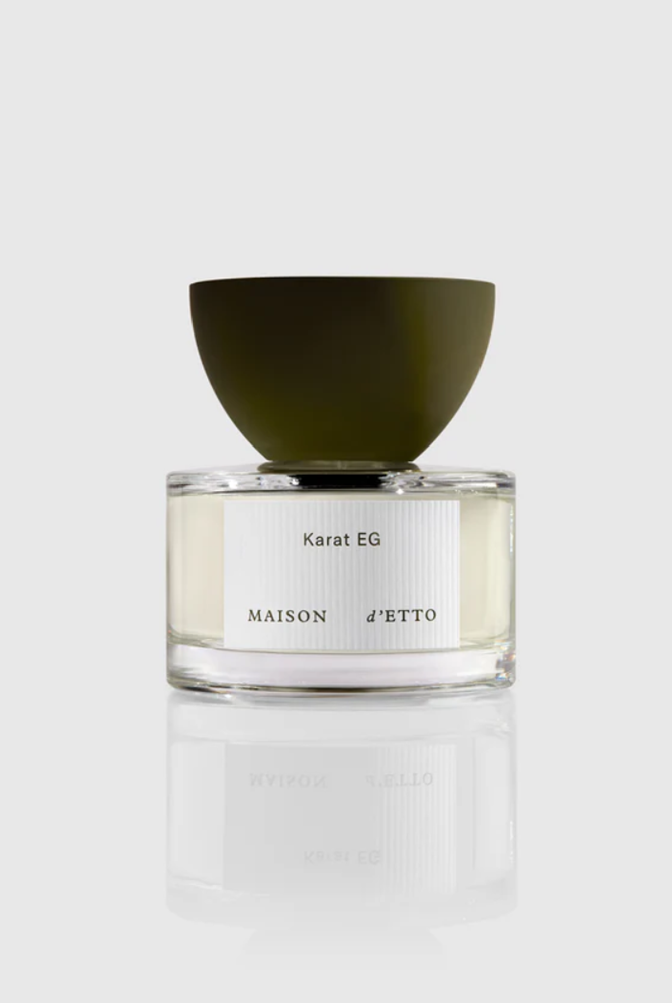 Perfume bottle with green cap on a white background