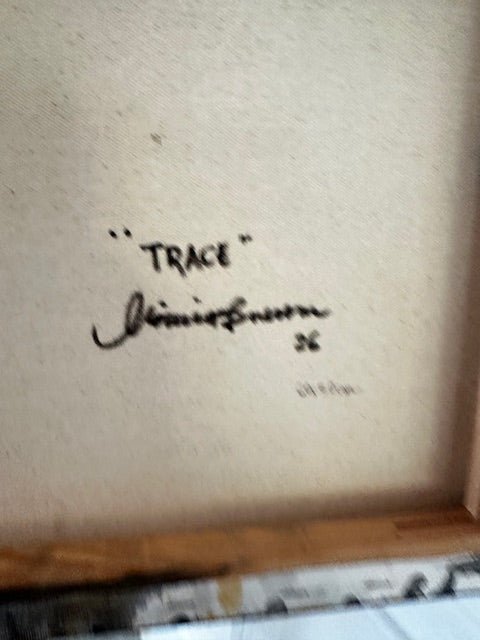 Signature on a textured surface with a blurred background