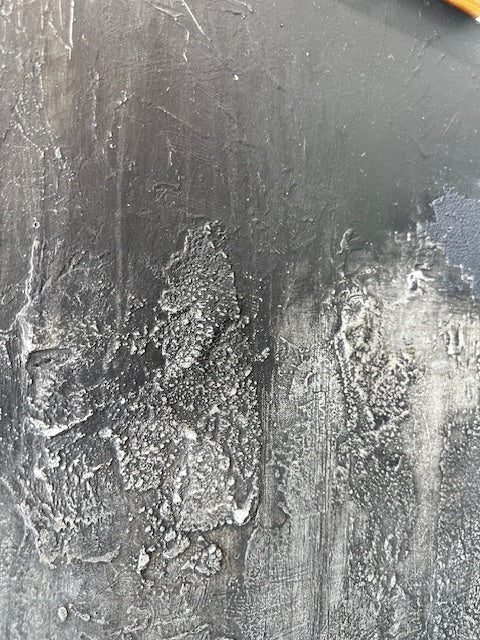 Close-up of a textured metal surface with visible scratches and imperfections