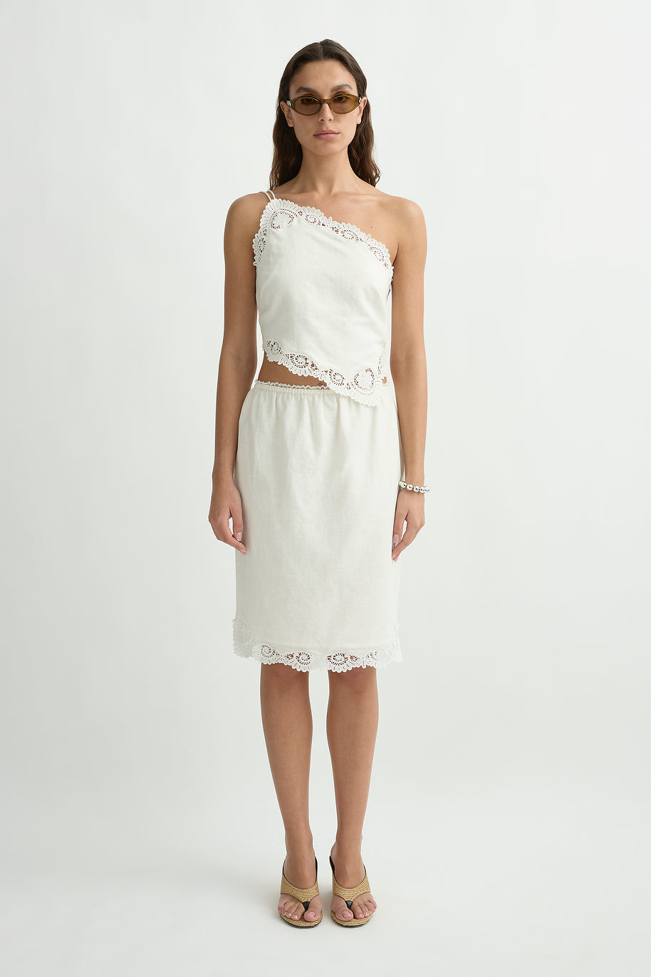 Woman wearing the posse darya top standing in front of a cream background