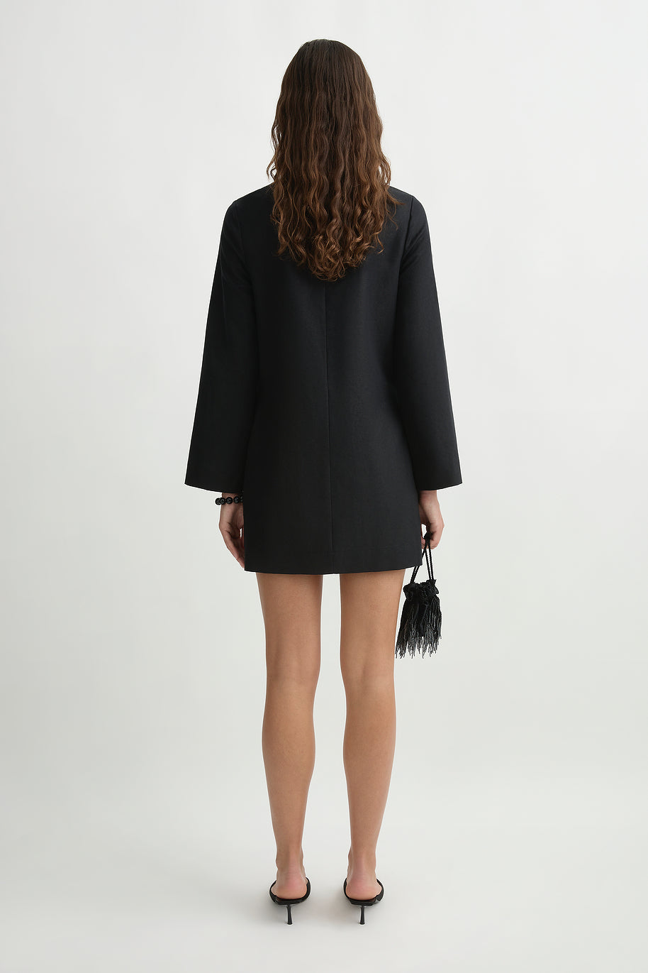 back image of a woman wearing the Posse Yvette Kaftan Dress