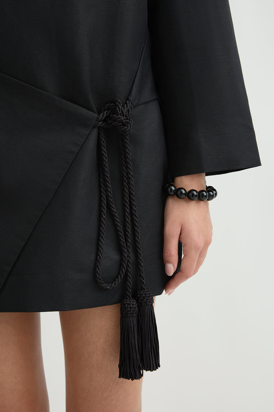 close up image of a woman wearing the Posse Yvette Kaftan Dress