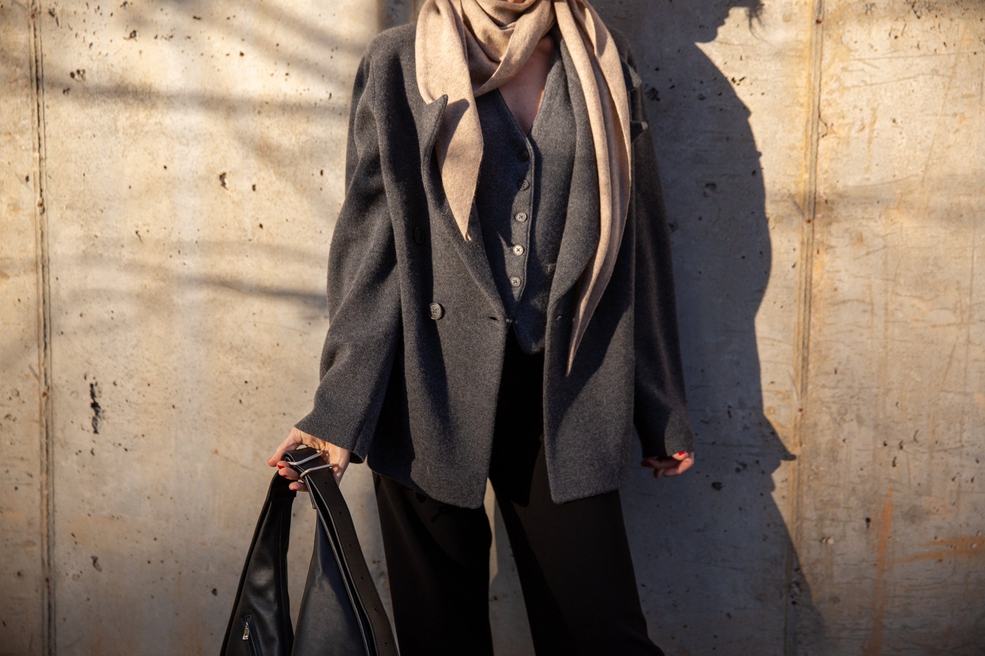 image of a woman wearing the Rachel Comey Nelam Pants and Guest in Residence Tailored Blazer and Vest with the Janessa Leone Handbag