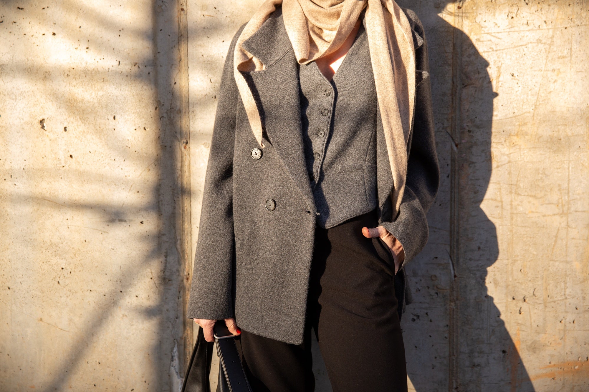 image of a woman wearing the Rachel Comey Nelam Pants and Guest in Residence Tailored Blazer and Vest with the Janessa Leone Handbag