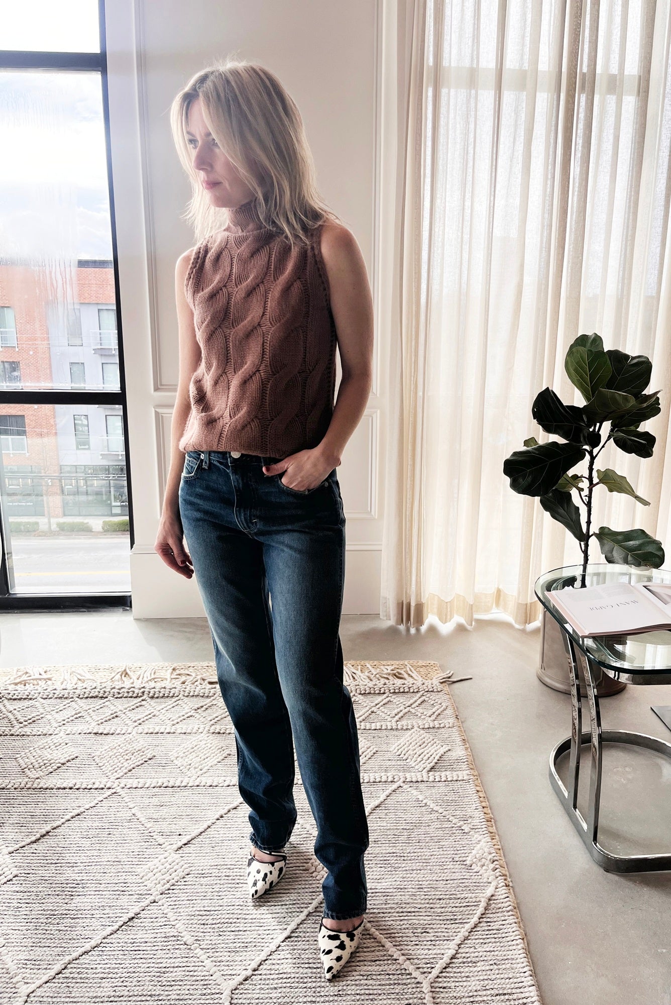 image of a woman wearing the Sablyn Salvia Sweater and Amo Mira Jeans