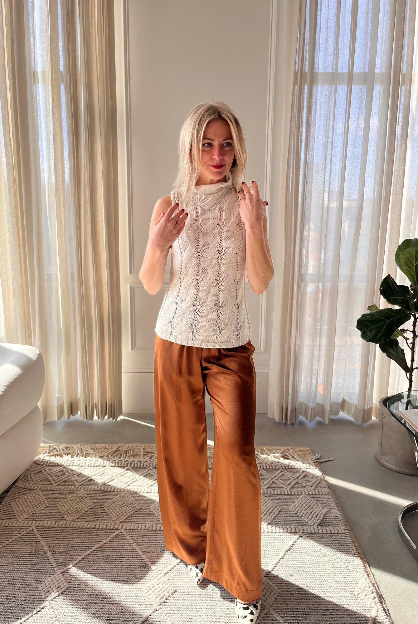 image of a woman wearing the Sablyn Salvia Sweater and Brynn Silk Pants