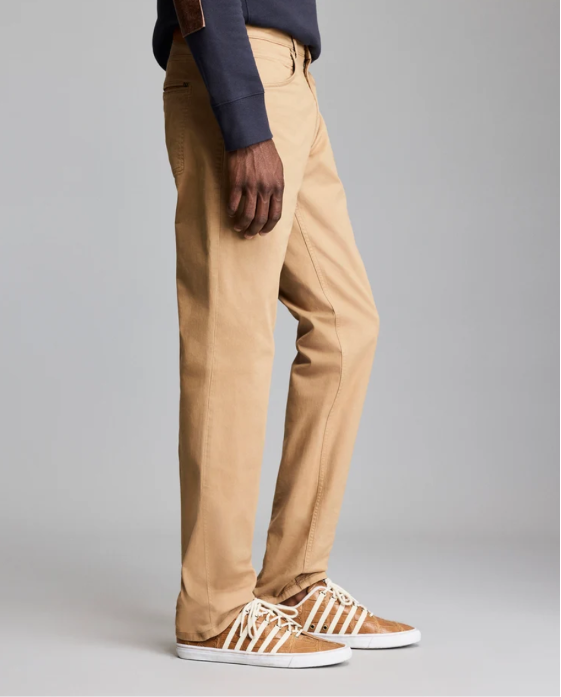 Man wearing the Billy Reid Cochran Jean in British Khaki standing against a white background