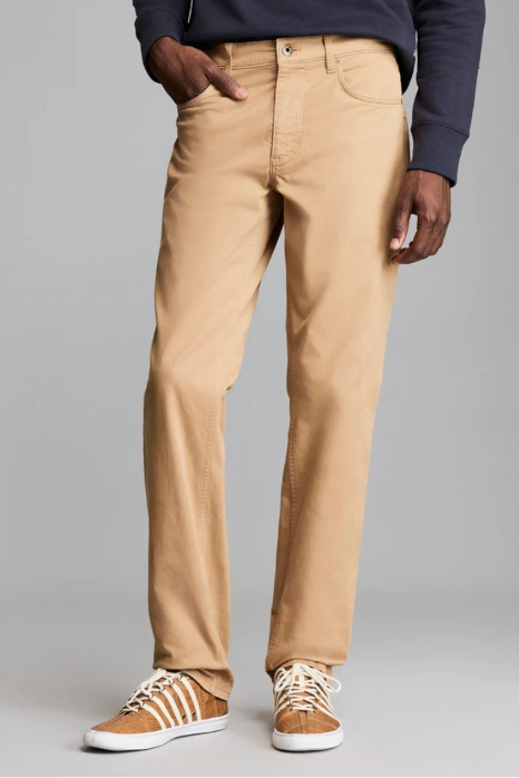 Man wearing the Billy Reid Cochran Jean in British Khaki standing against a white background