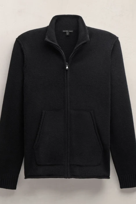 A black zip-up knit sweater with a stand collar and two front kangaroo pockets, displayed flat against a light textured wall.
