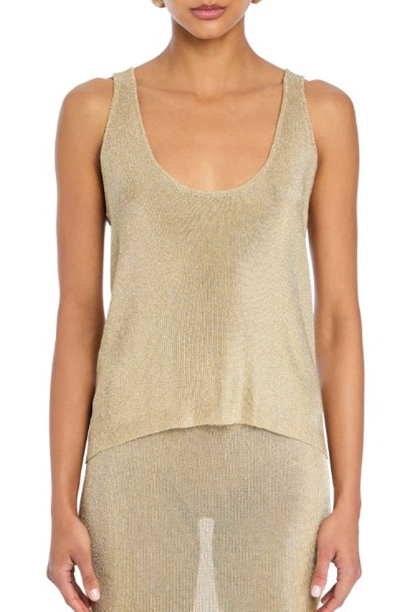 Woman wearing a beige tank top and pants on a white background