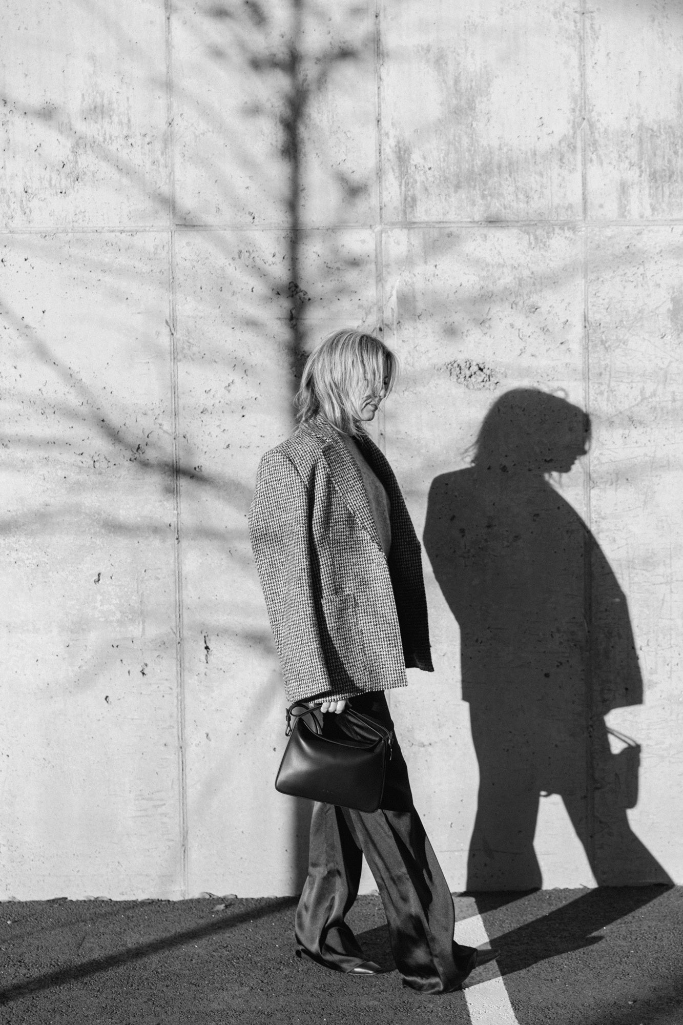 image of a woman wearing the House of Dagmar Coat, Aesther Ekme Bag and Seroya Viva Satin Pants