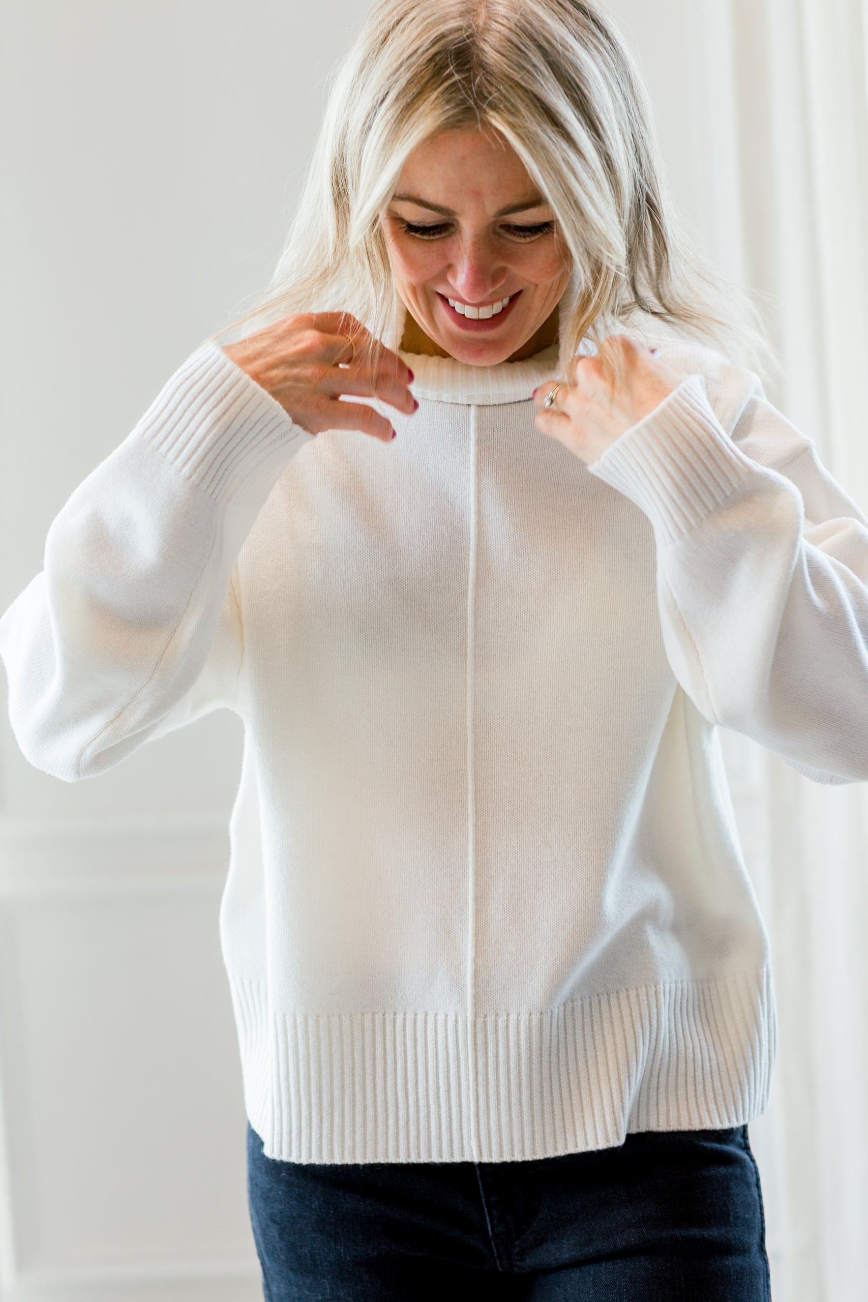 image of a woman wearing the allude turtleneck sweater