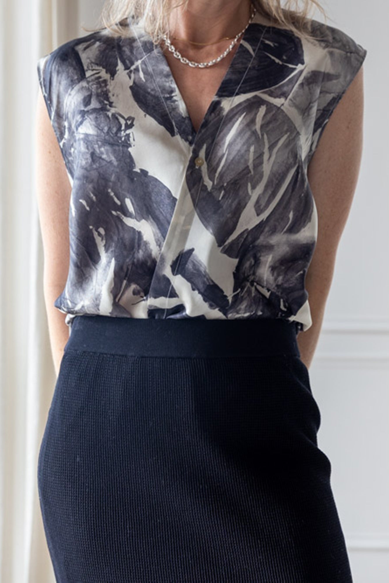 image of a woman wearing the Alysi Silk Crossover Top and Mesh Skirt