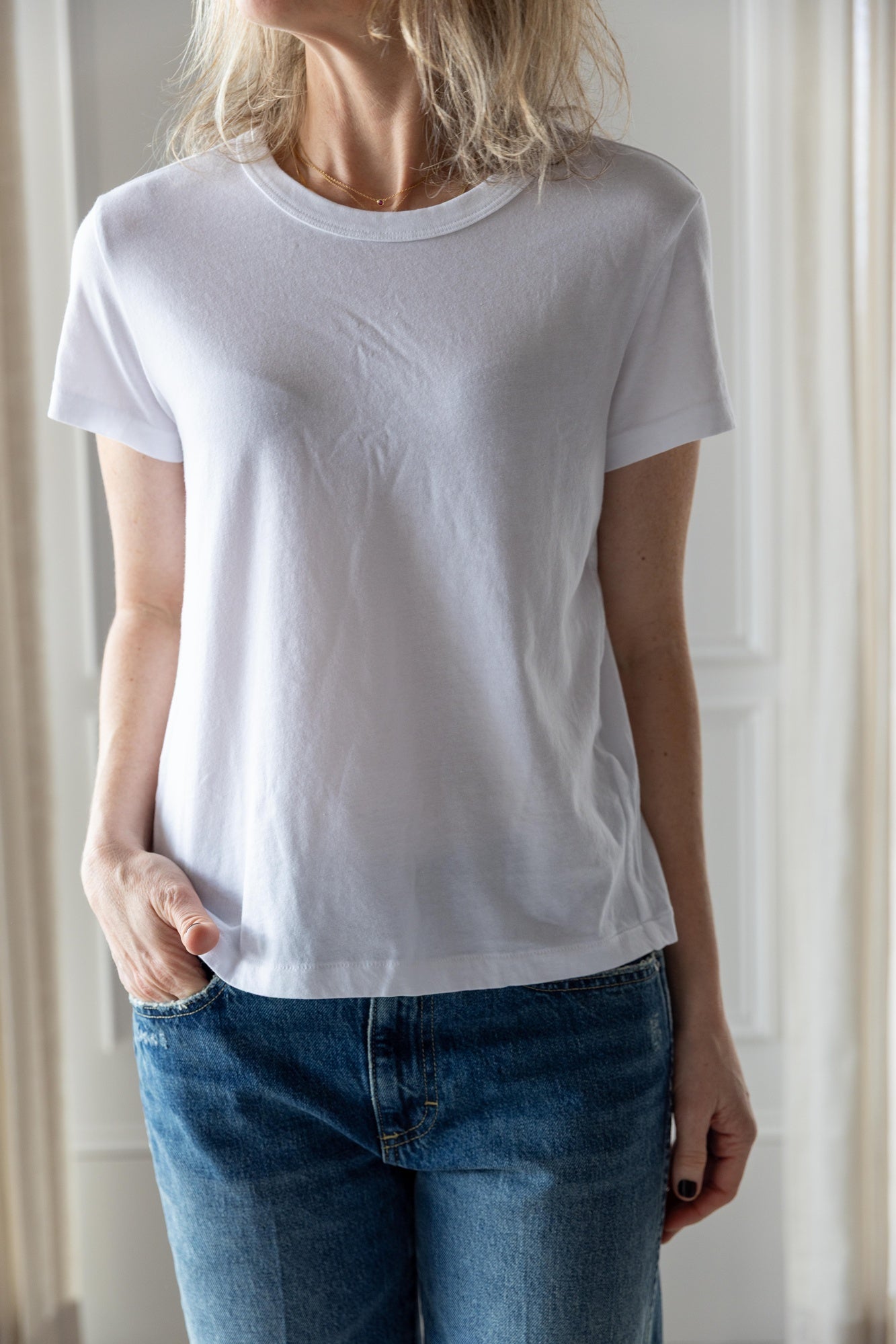image of a woman wearing the Amo Lovey Tee in White