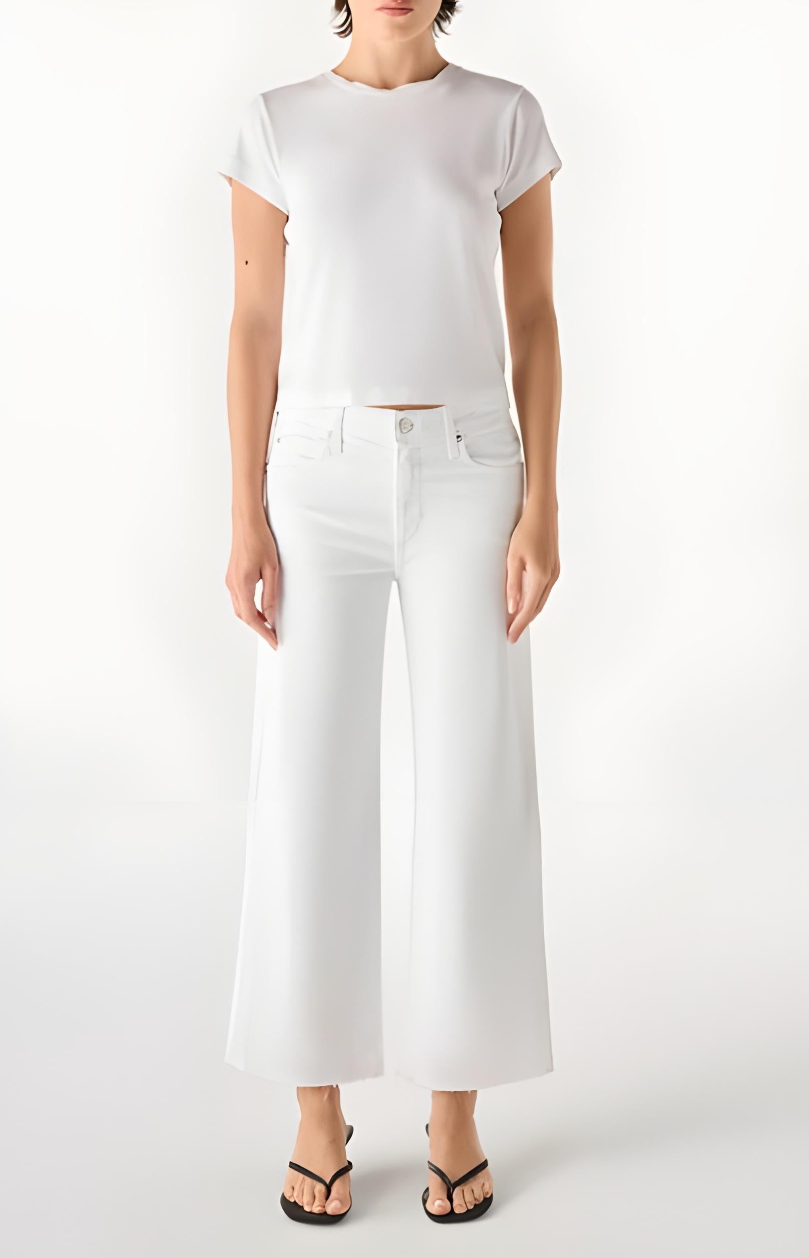 Person wearing a white t-shirt and white wide-leg jeans on a white background