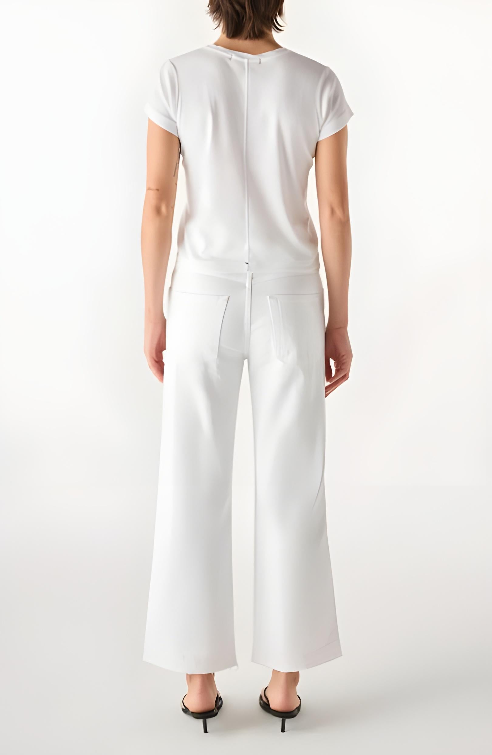 Person wearing a white outfit with wide-leg pants on a white background