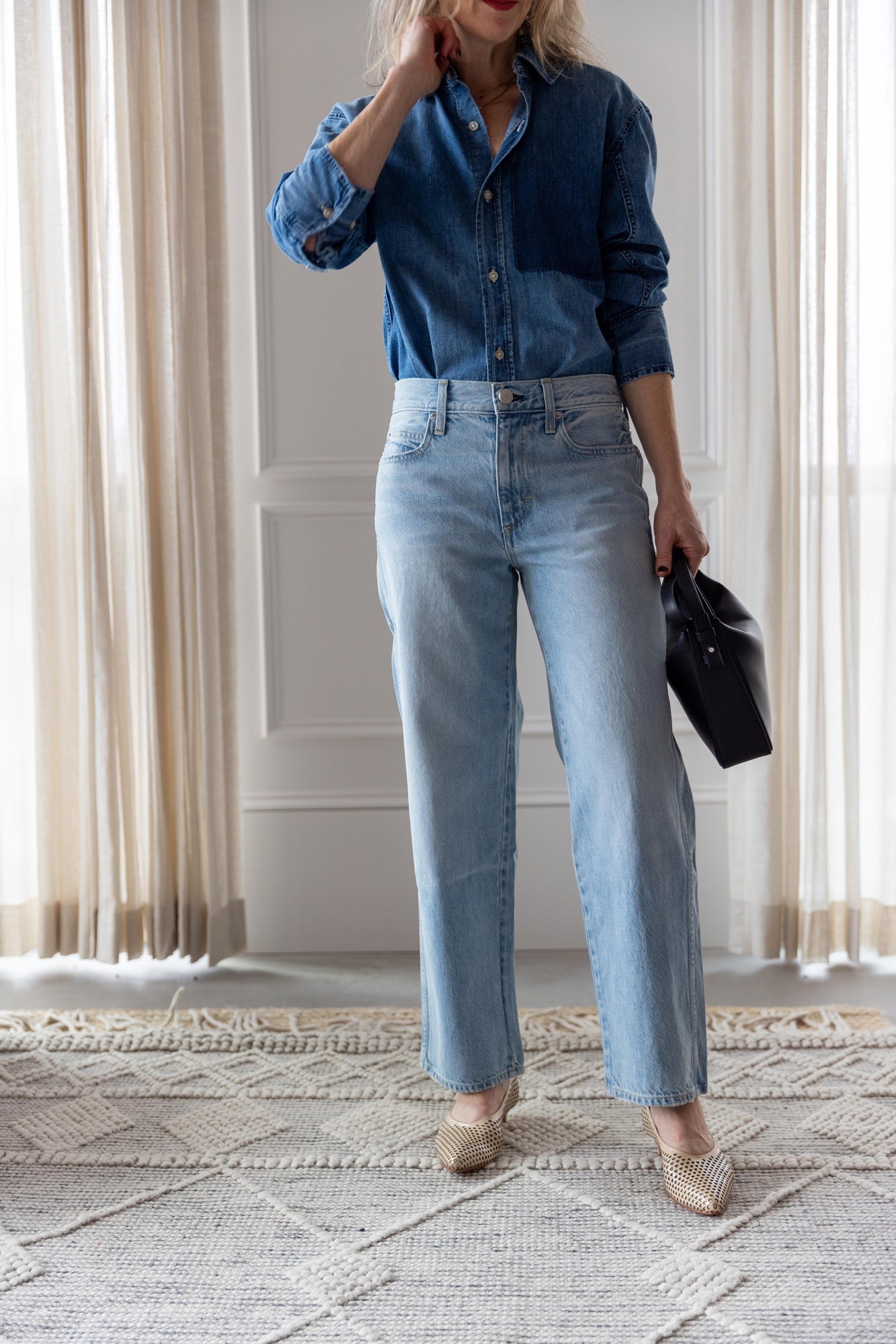 image of woman wearing the Amo Ruth denim shirt and billie jeans with the Aesther Ekme Baguette Bag