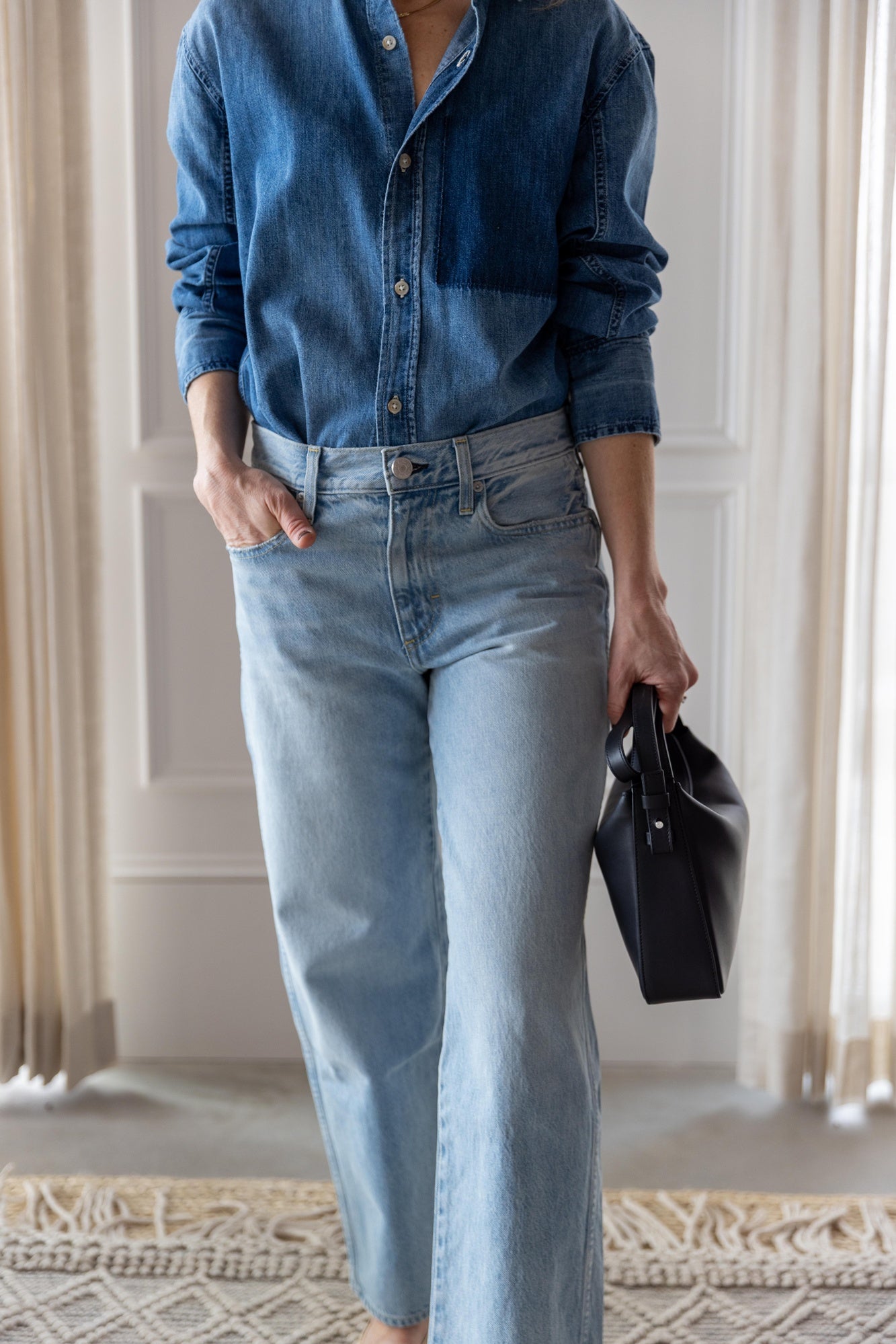 image of woman wearing the Amo Ruth denim shirt and billie jeans with the Aesther Ekme Baguette Bag