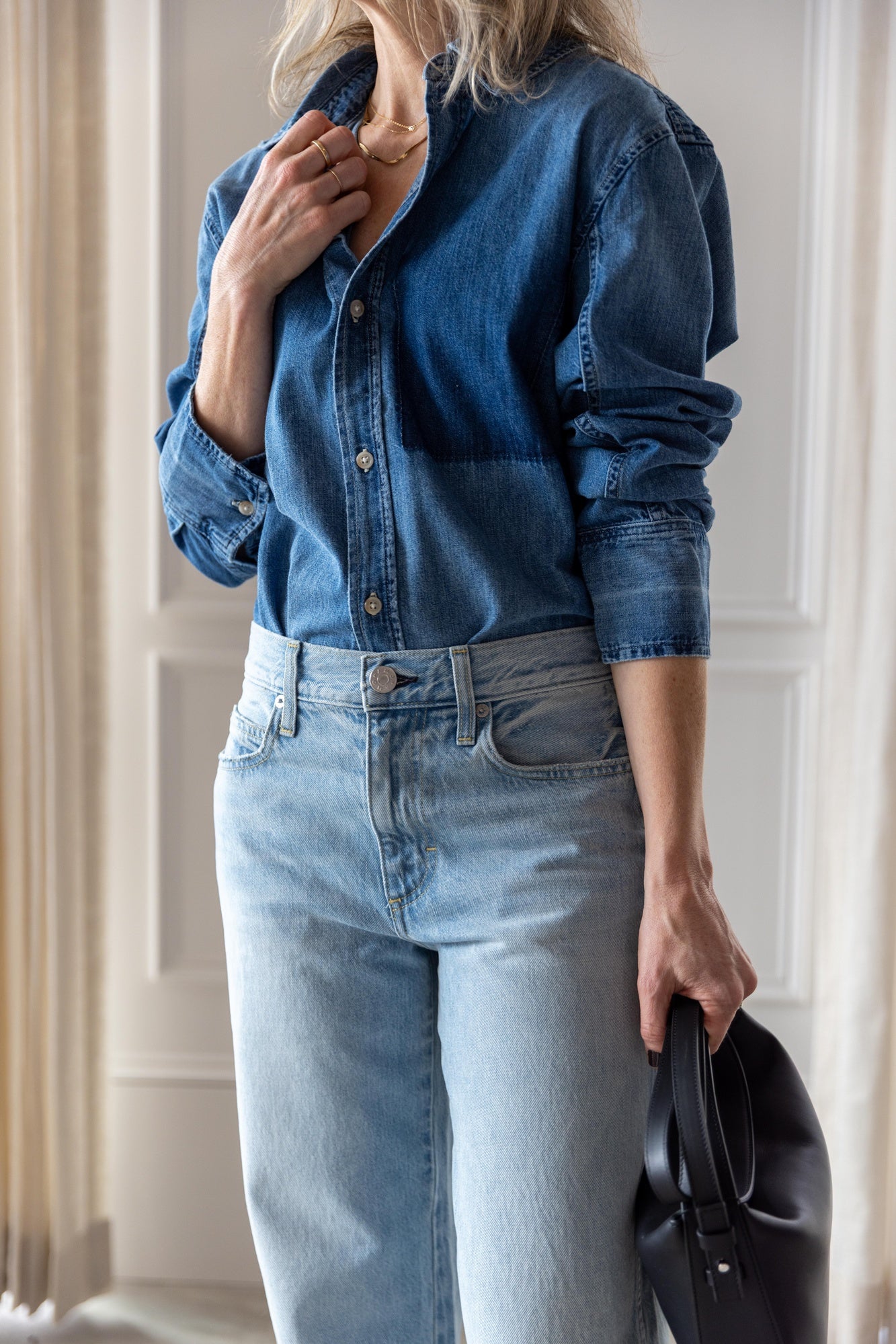 image of woman wearing the Amo Ruth denim shirt and billie jeans with the Aesther Ekme Baguette Bag