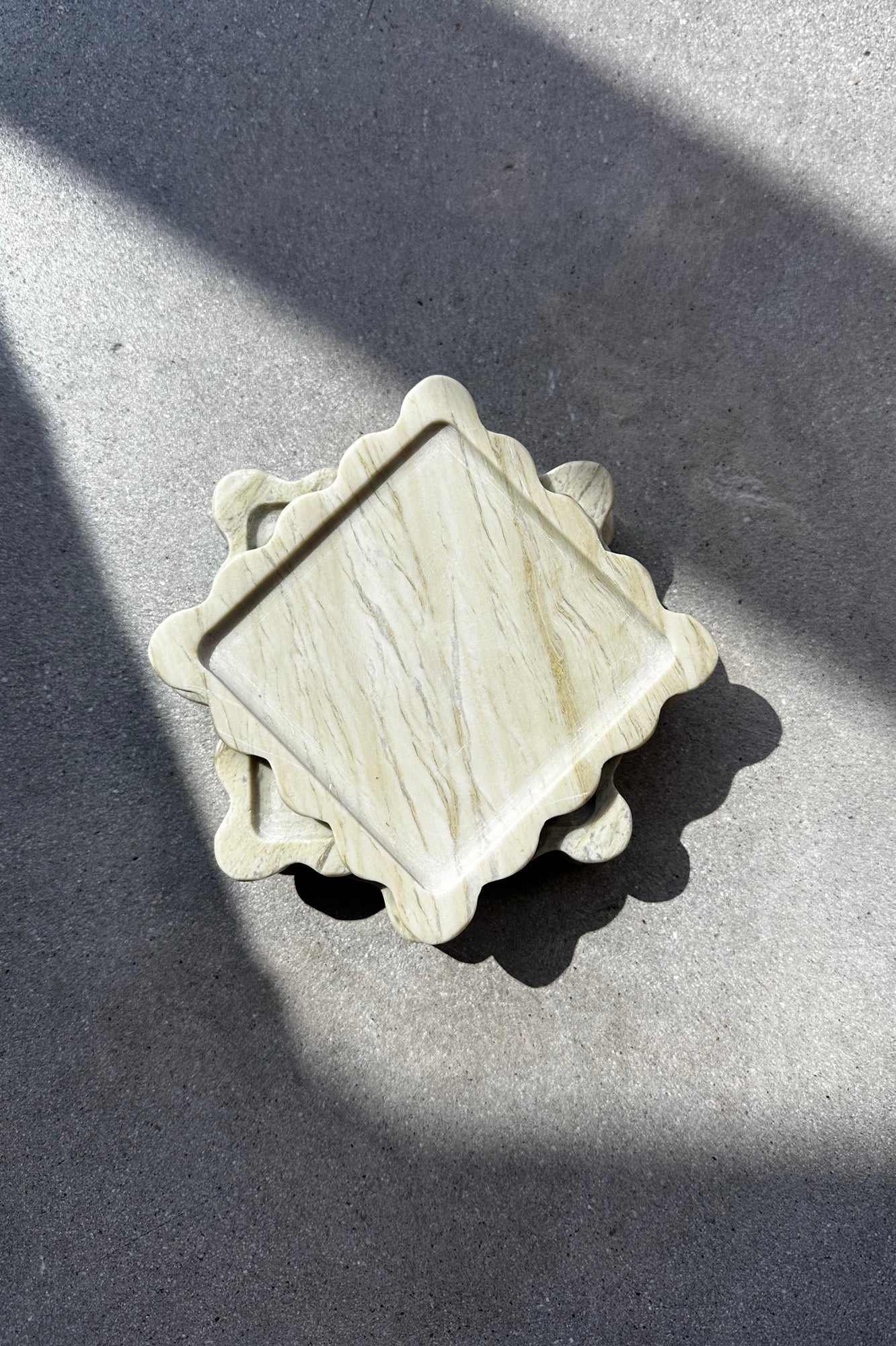 Decorative stone object on a gray surface with a shadow