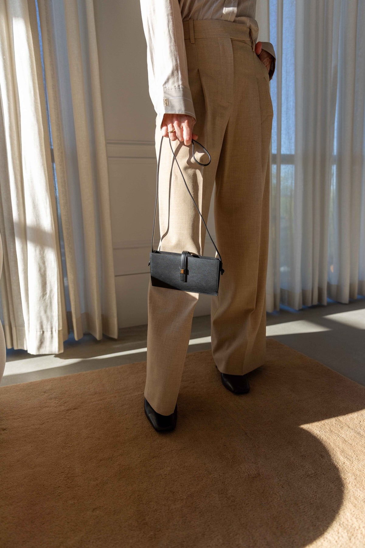 by Malene Birger Cymbaria Pants in sand, high-rise wide-leg pleated trousers with a white shirt and black bag
