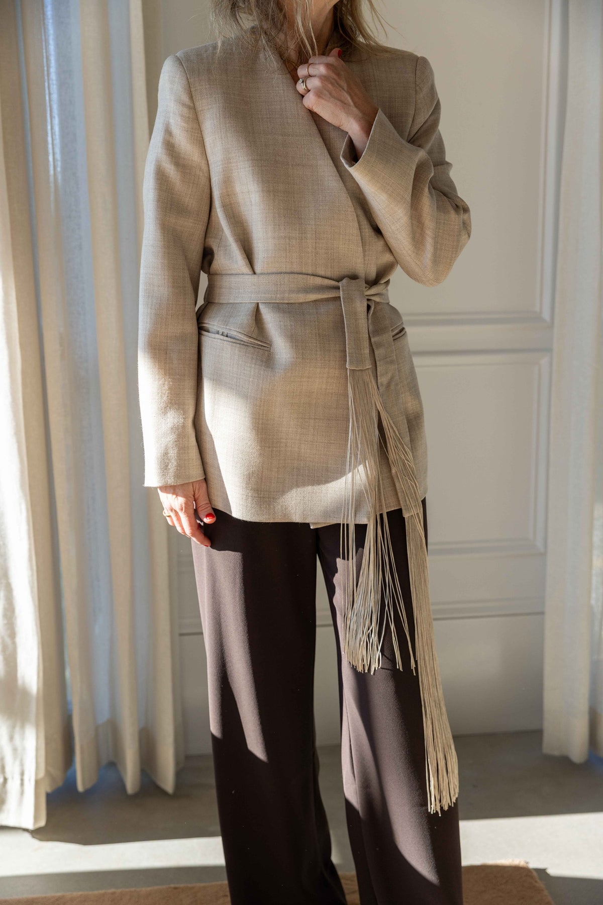 by Malene Birger Emma Blazer in grey brown melange virgin wool, belted with the fringed tie over brown wide-leg trousers, front view