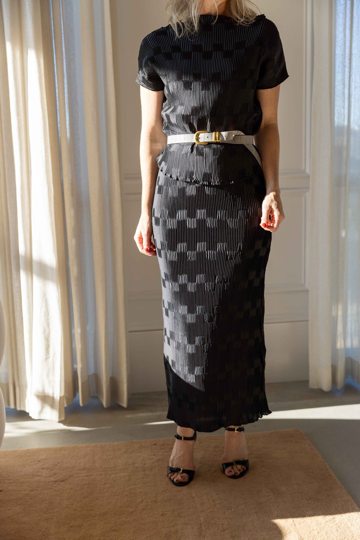 by Malene Birger Lianna Top and Lian Maxi Skirt in black pleated satin with a Zoilo Belt and strappy sandals, full-length view