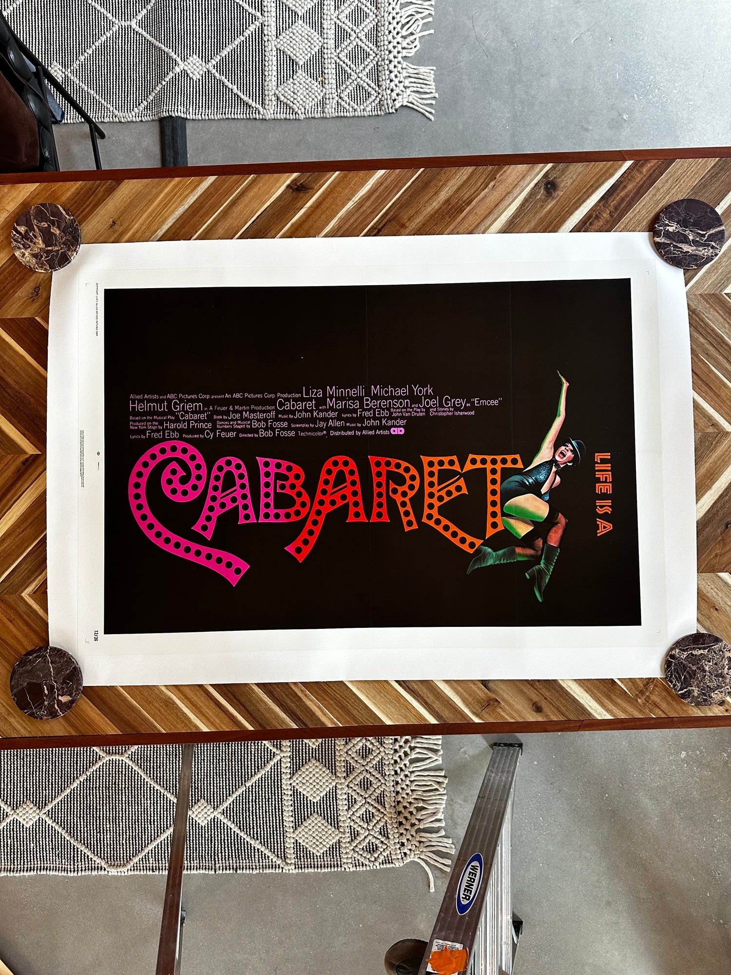 Framed poster of 'Cabaret' with colorful text and a dancer on a wooden table.