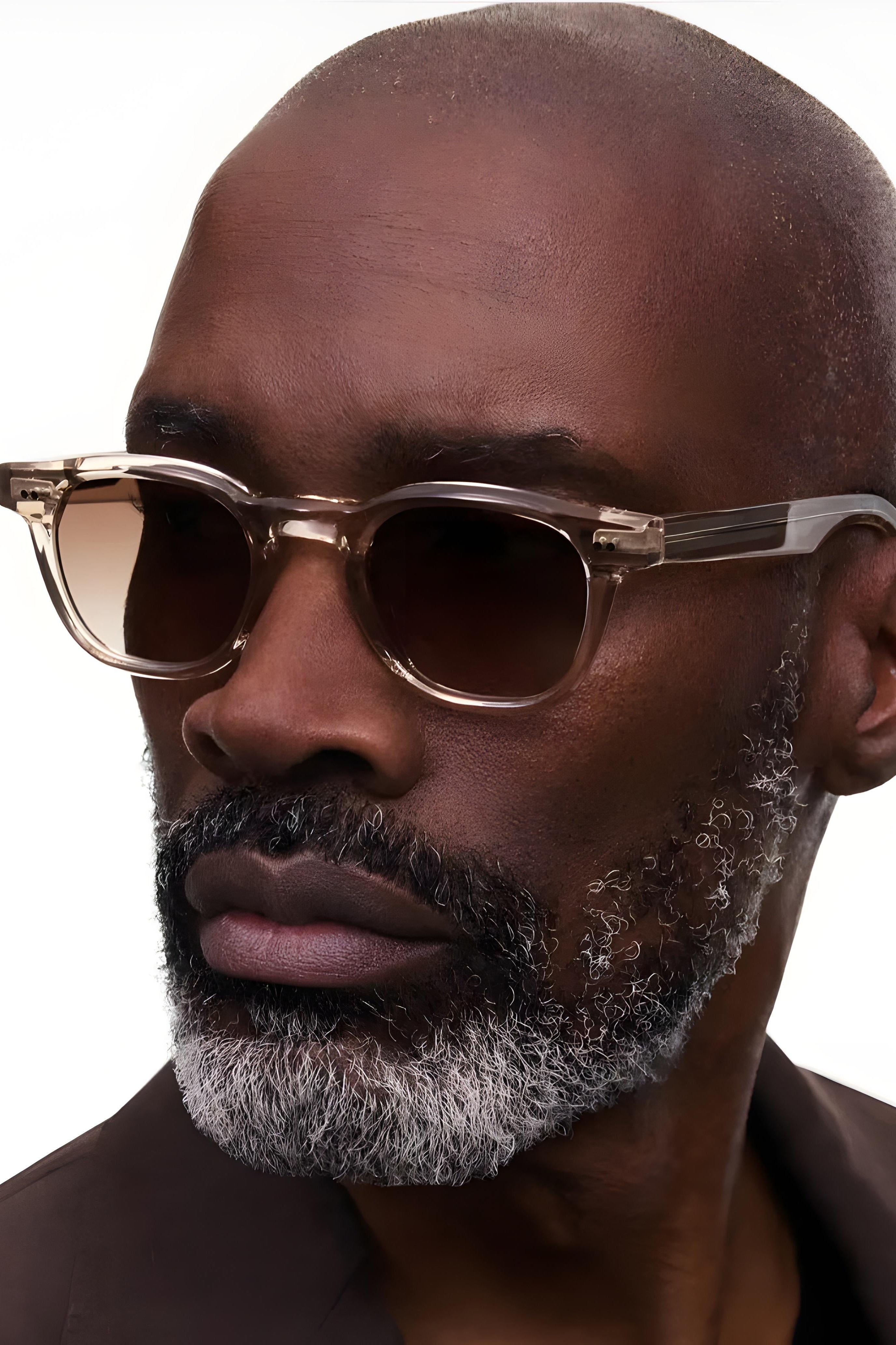 Man wearing sunglasses with a neutral background
