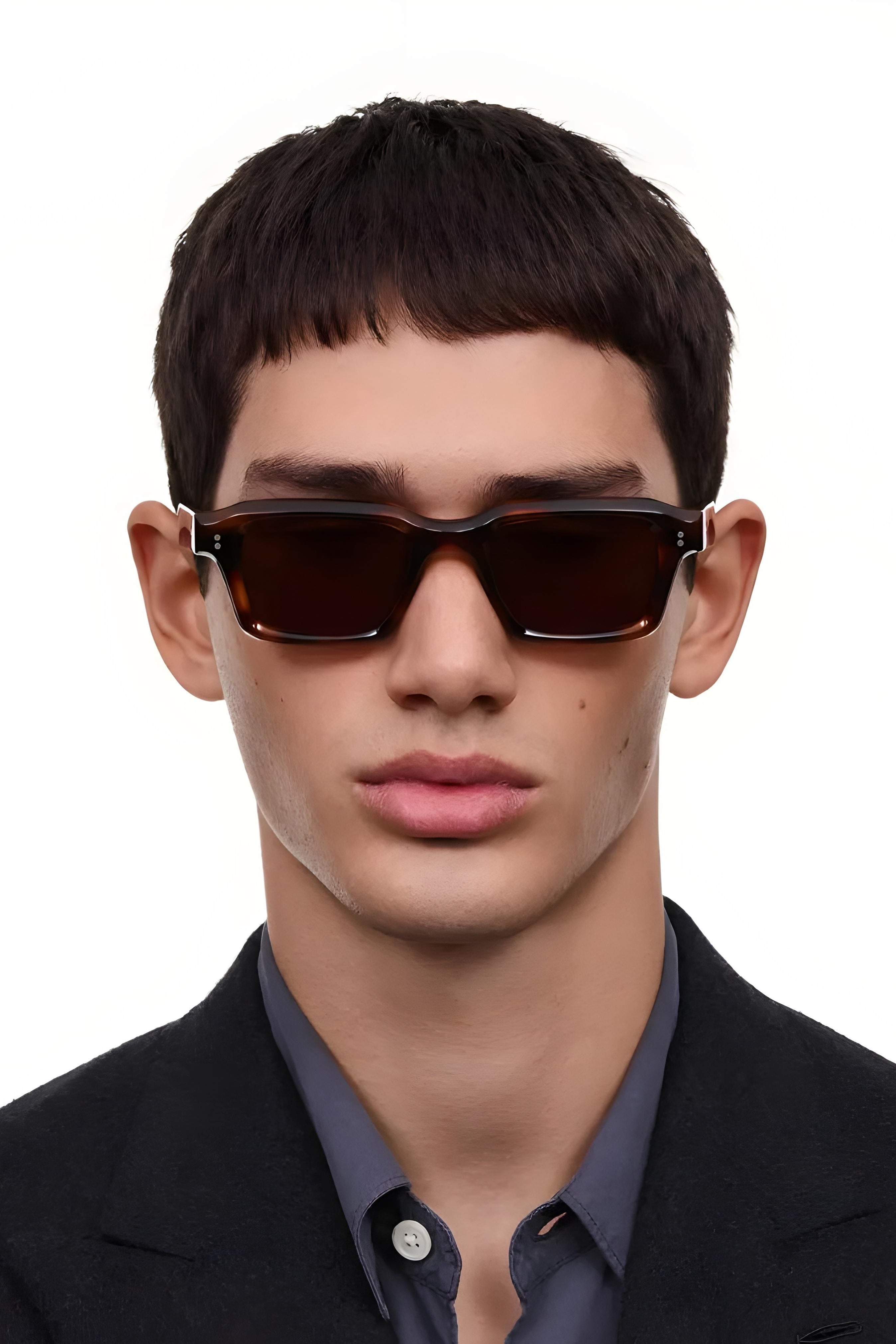 Man wearing dark sunglasses against a white background