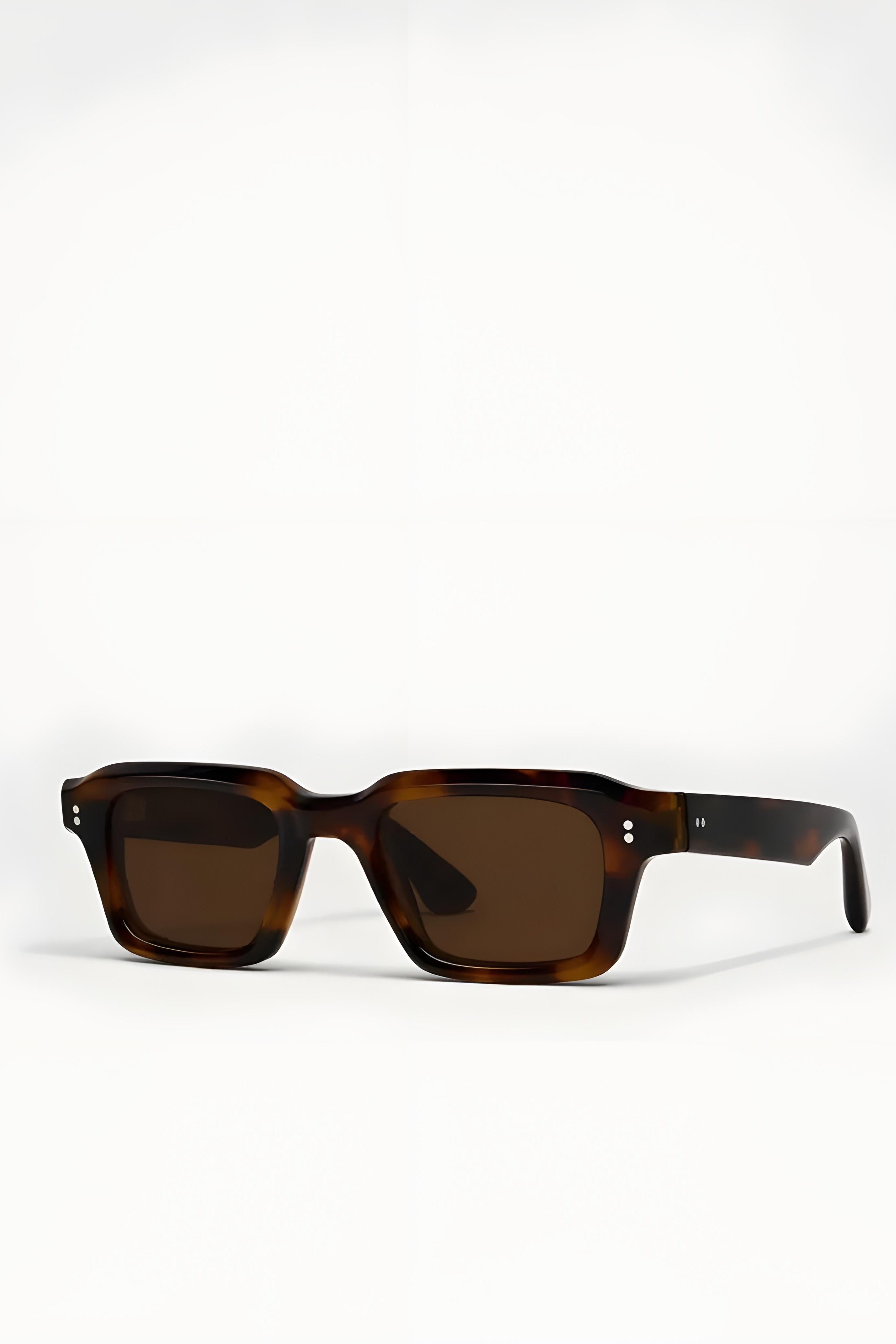 Sunglasses with tortoiseshell frame and brown lenses on a white background