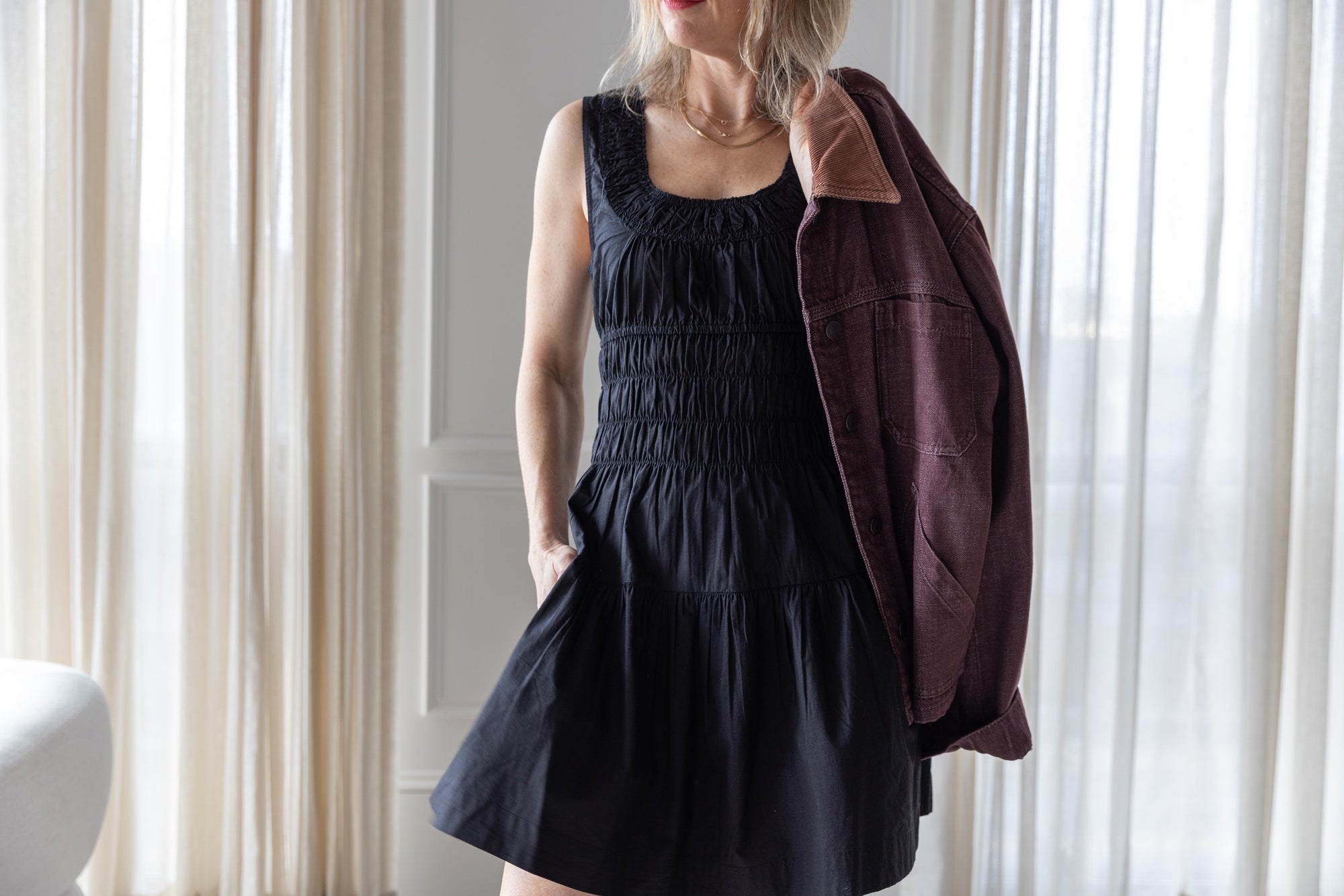image of a woman wearing the Ciao Lucia Kala dress and Jeanerica Nua Denim Jacket