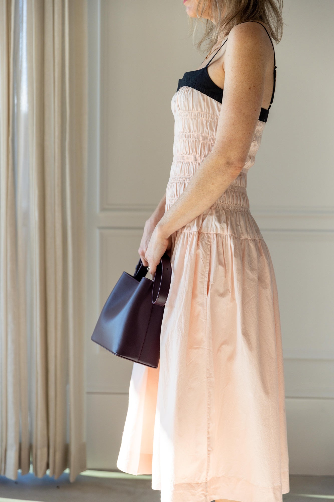 side image of a woman wearing the Ciao Lucia Rosella Dress in Powder Pink