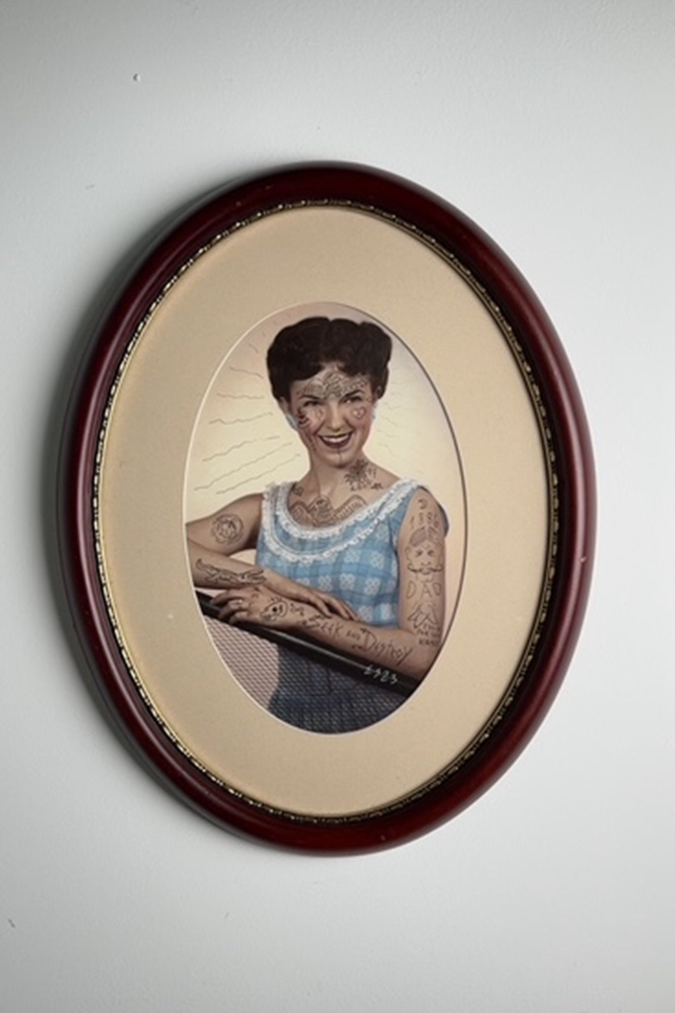 This particular piece is beautifully framed in a deep burgundy oval frame with gold trim, true to the artist’s aesthetic and attention to presentation