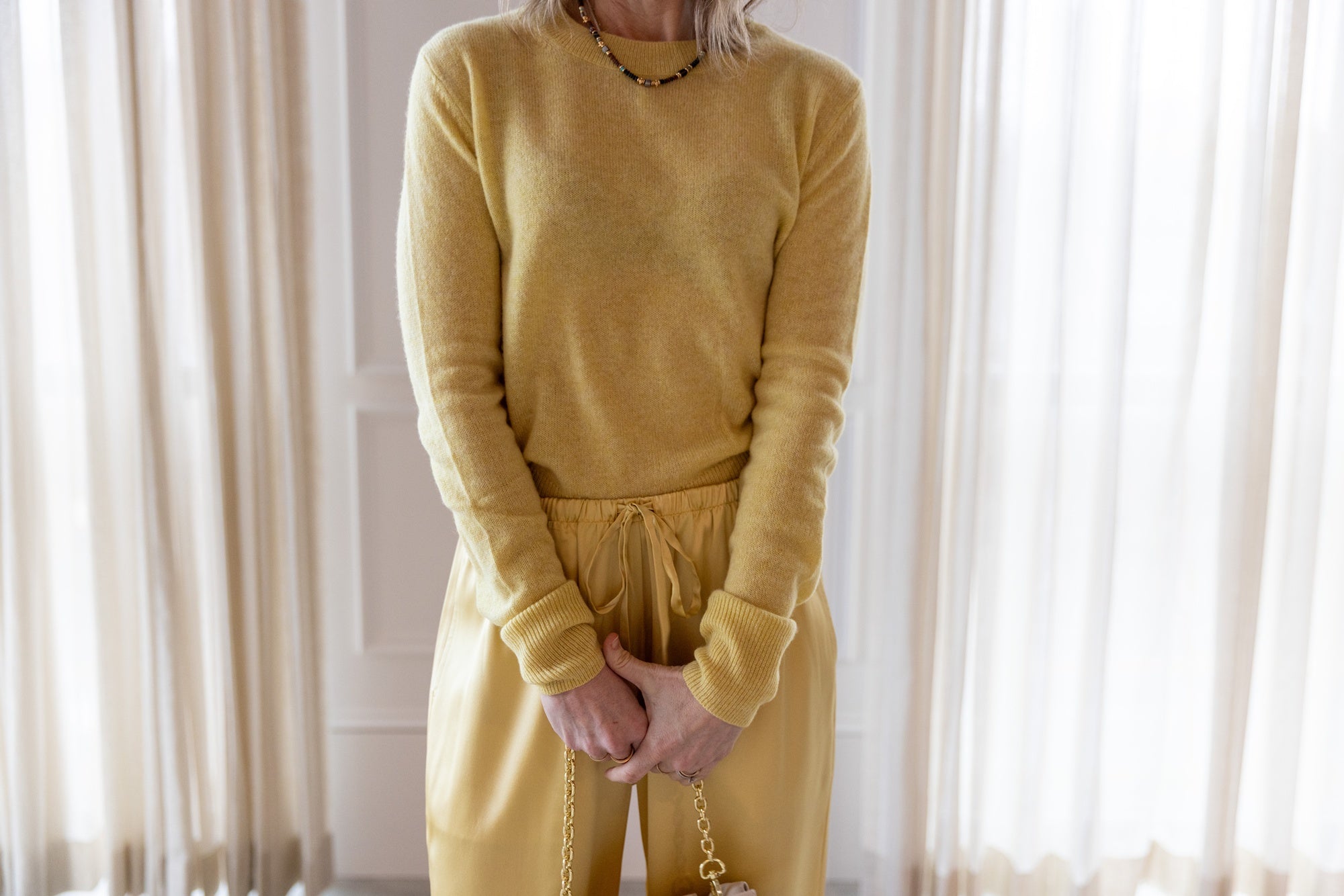 close up image of a woman wearing the Eterne Francis Sweater and Brody Pants