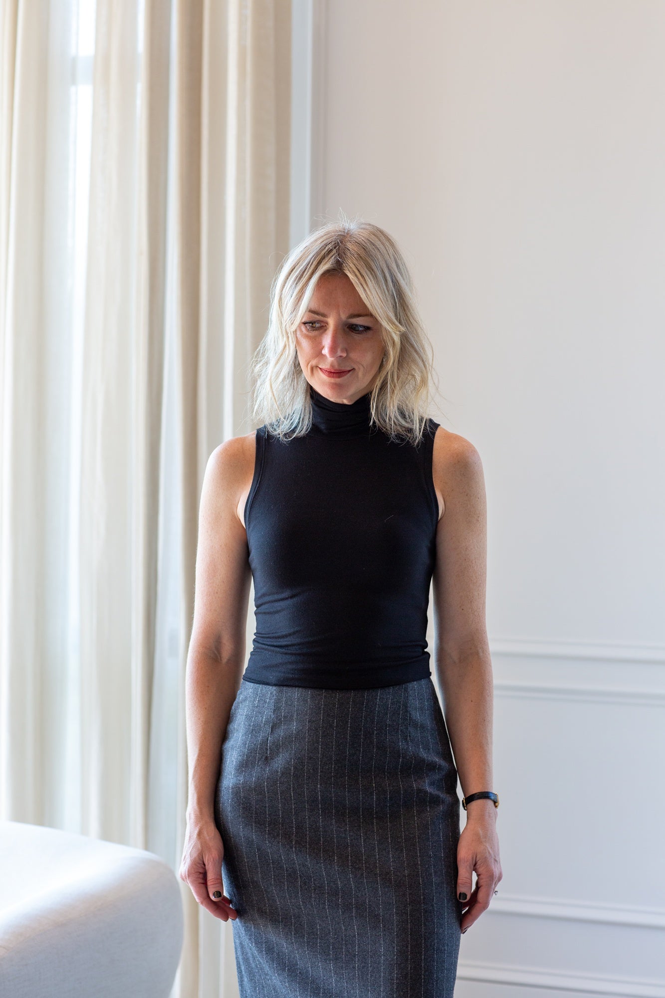model wearing the eterne harlow top and house of dagmar pinstripe pencil skirt