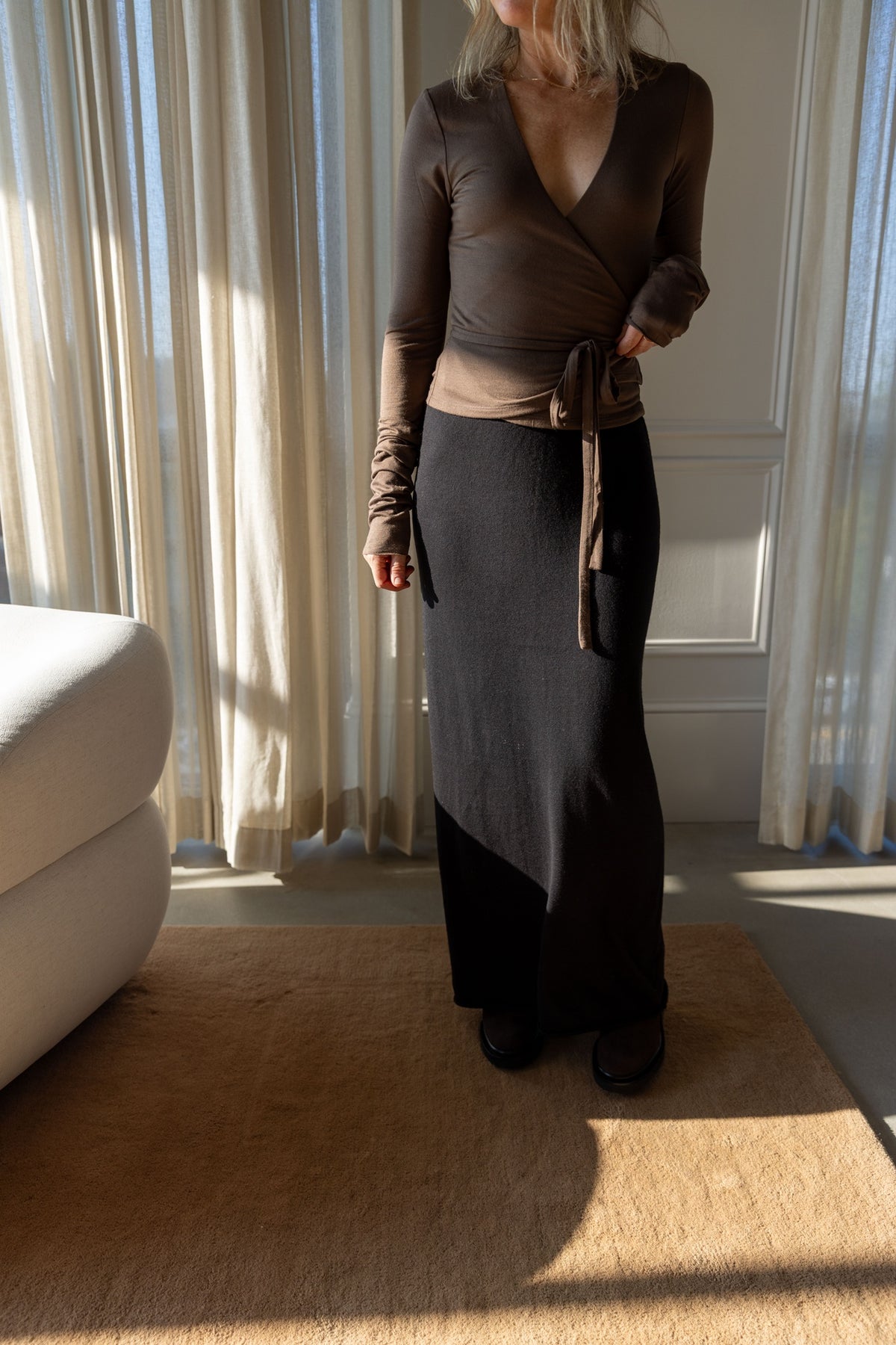 Eterne Wrap Top in mushroom, worn with the tie waist over the Lisa Yang Charlotta Skirt, full-length view