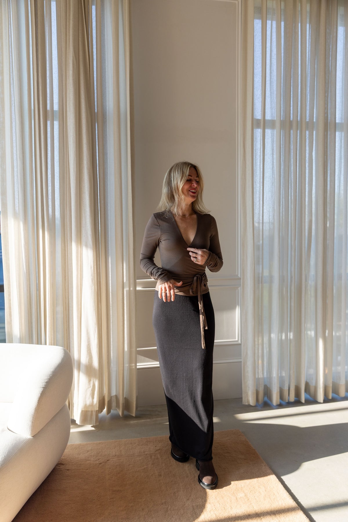 Lisa Yang Charlotta Skirt styled with an Eterne wrap top, full-length view in natural light
