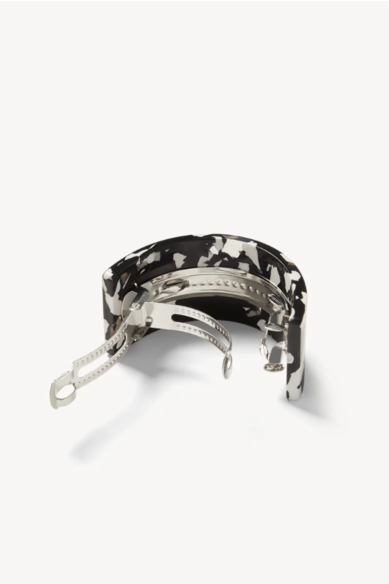 Backside  of a noir or Black and white patterned french pnoy barrette on a white background