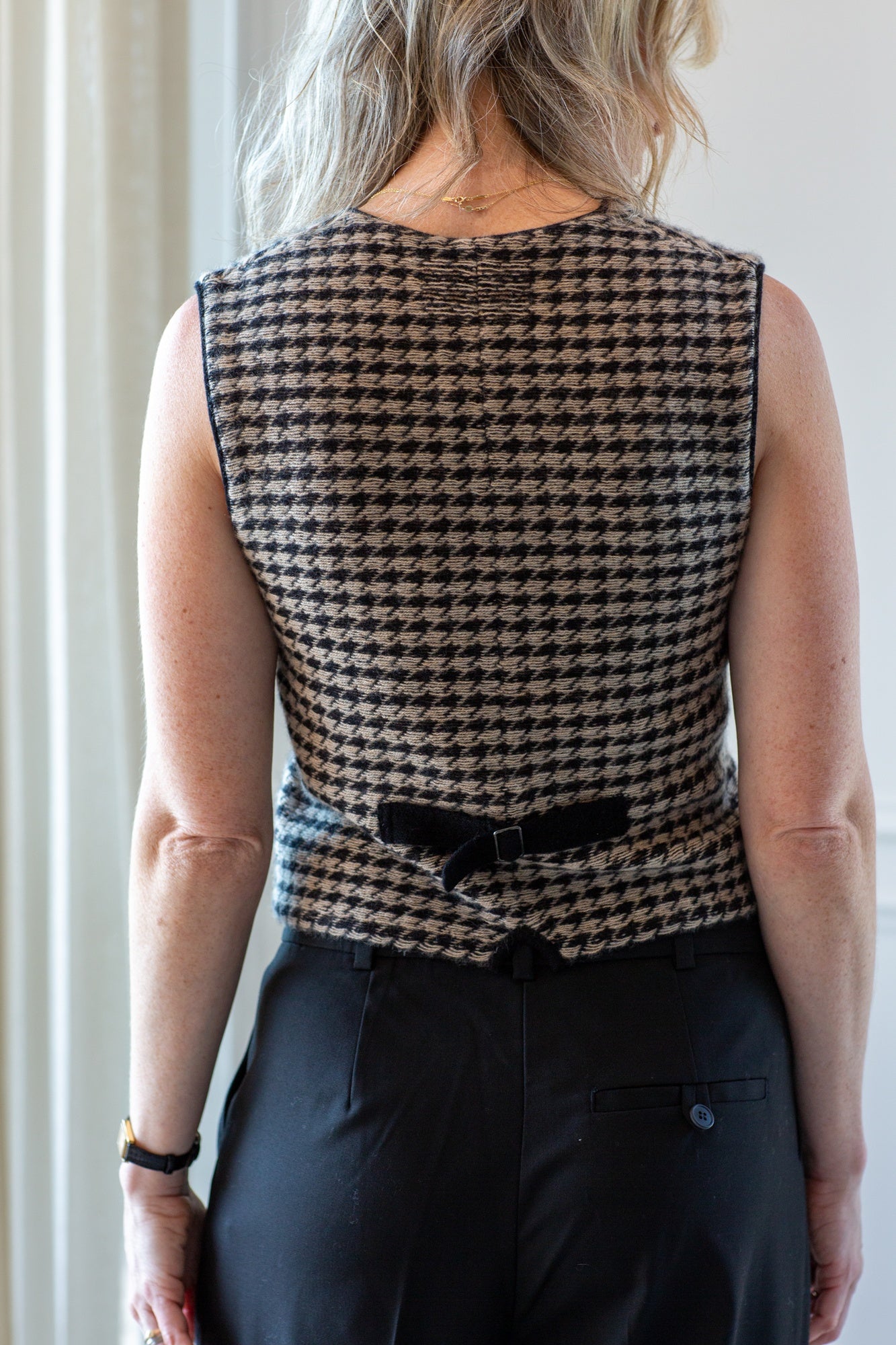 back image of a model wearing the guest in residence houndstooth vest and the Garment pluto pants