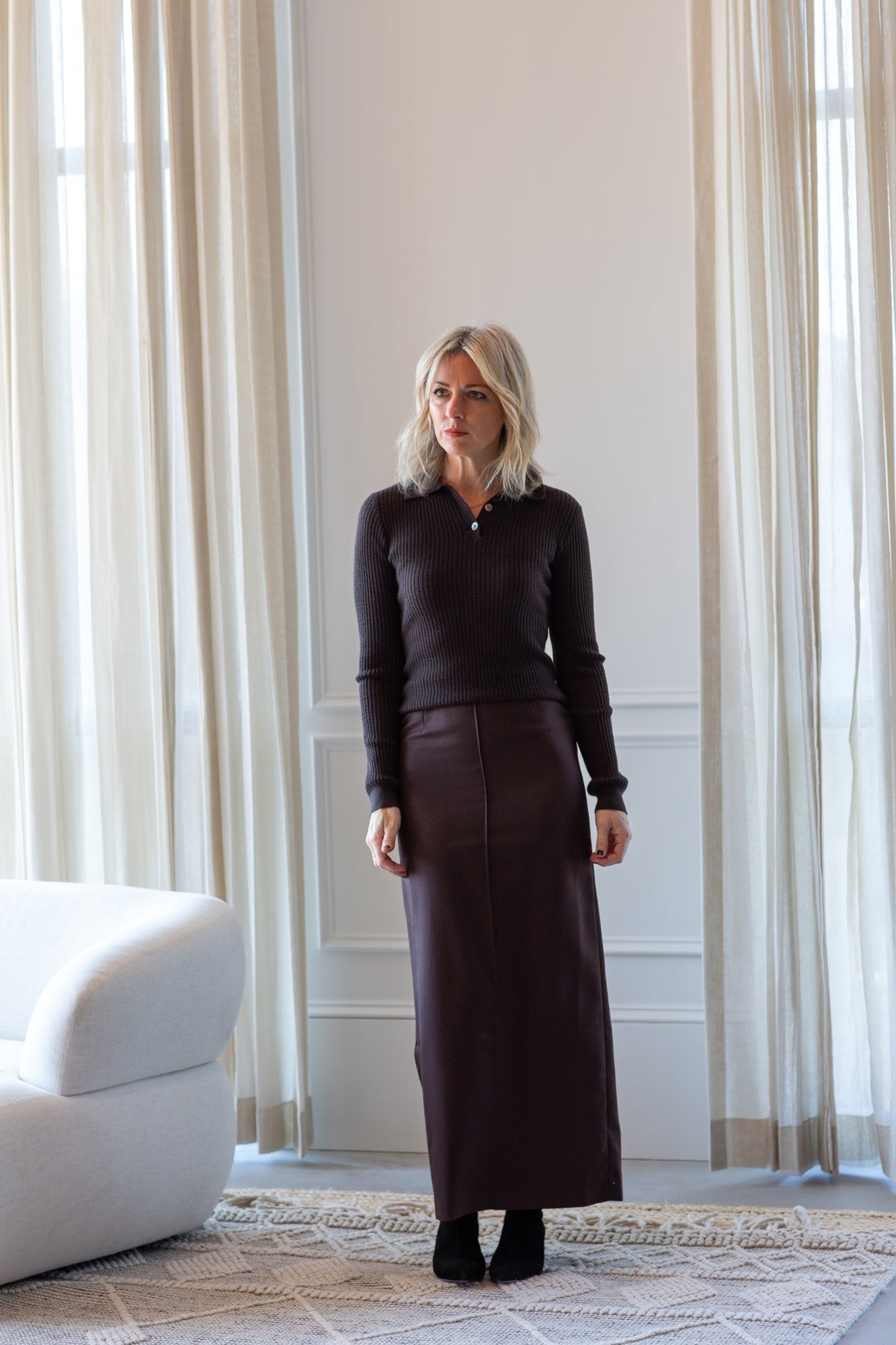 model wearing the guest in residence long sleeve polo and house of dagmar pencil skirt