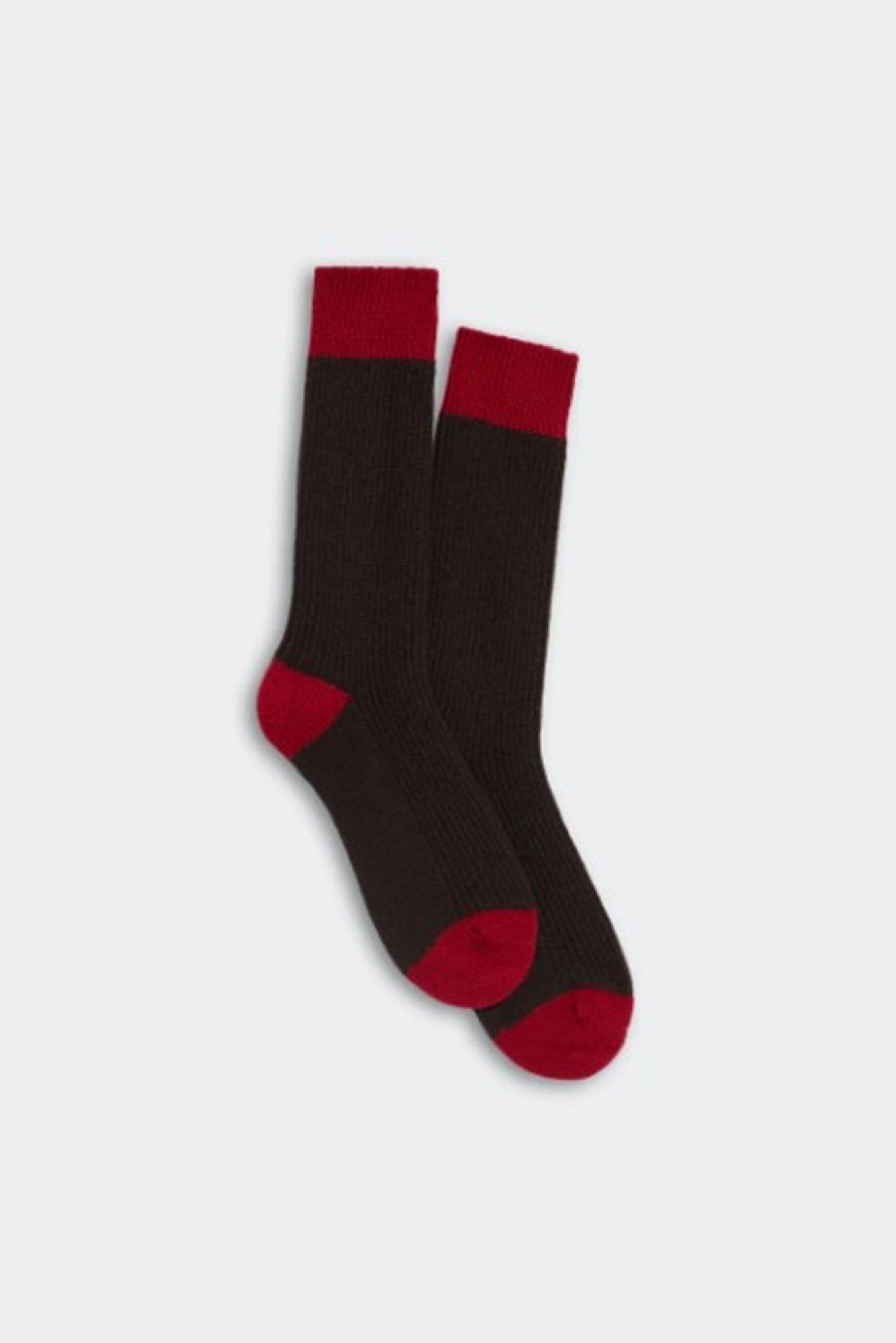 Pair of brown socks with red accents on a white background