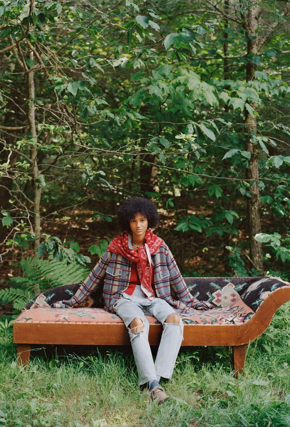 Person sitting on a bench in a forest