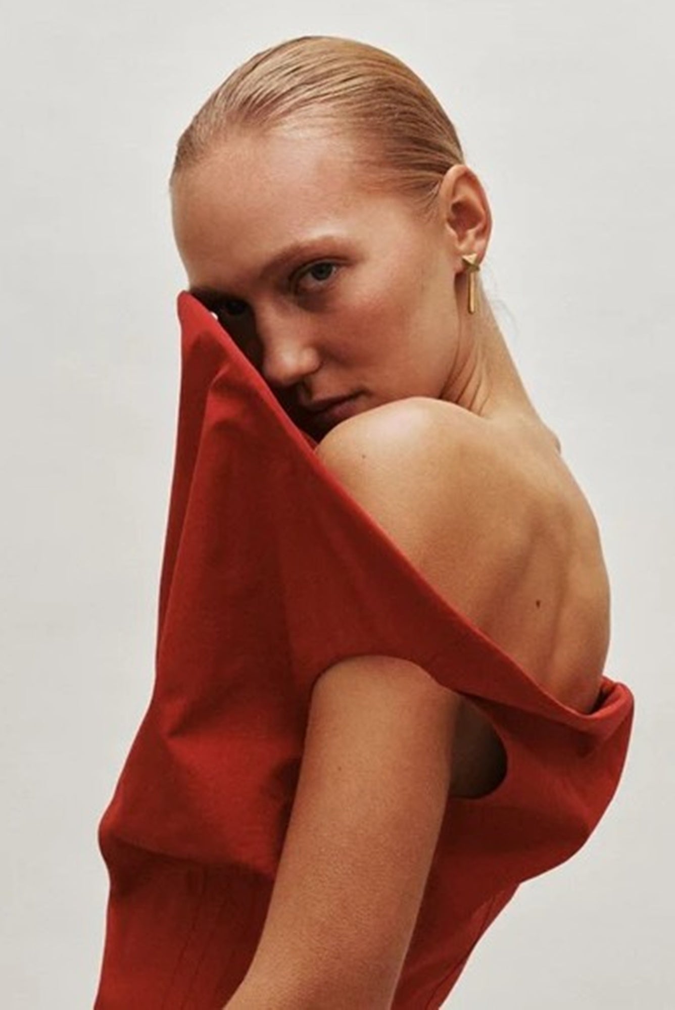 image of a woman wearing the Heaven Mayhem Iris earrings in gold