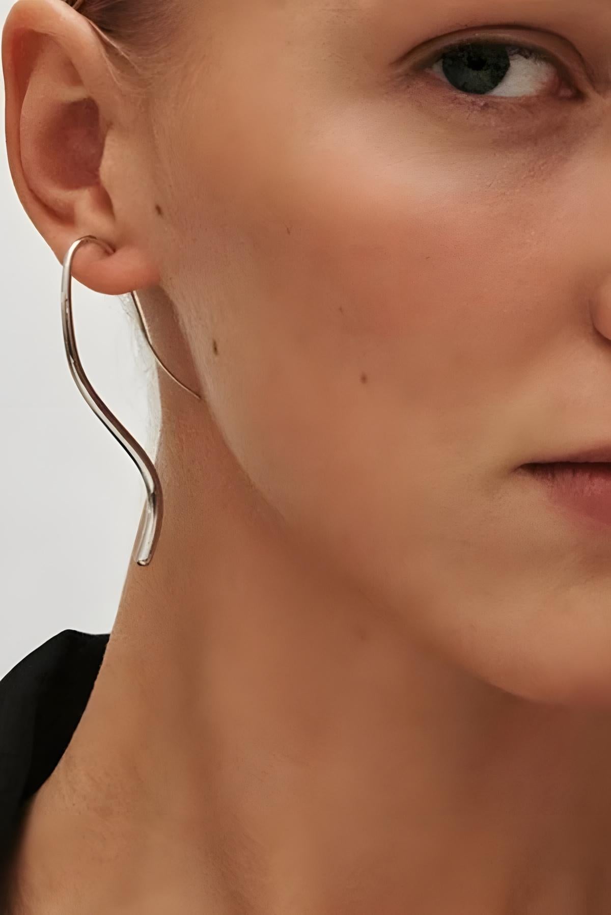 image of a woman wearing the Heaven Mayhem lenora earrings in silver