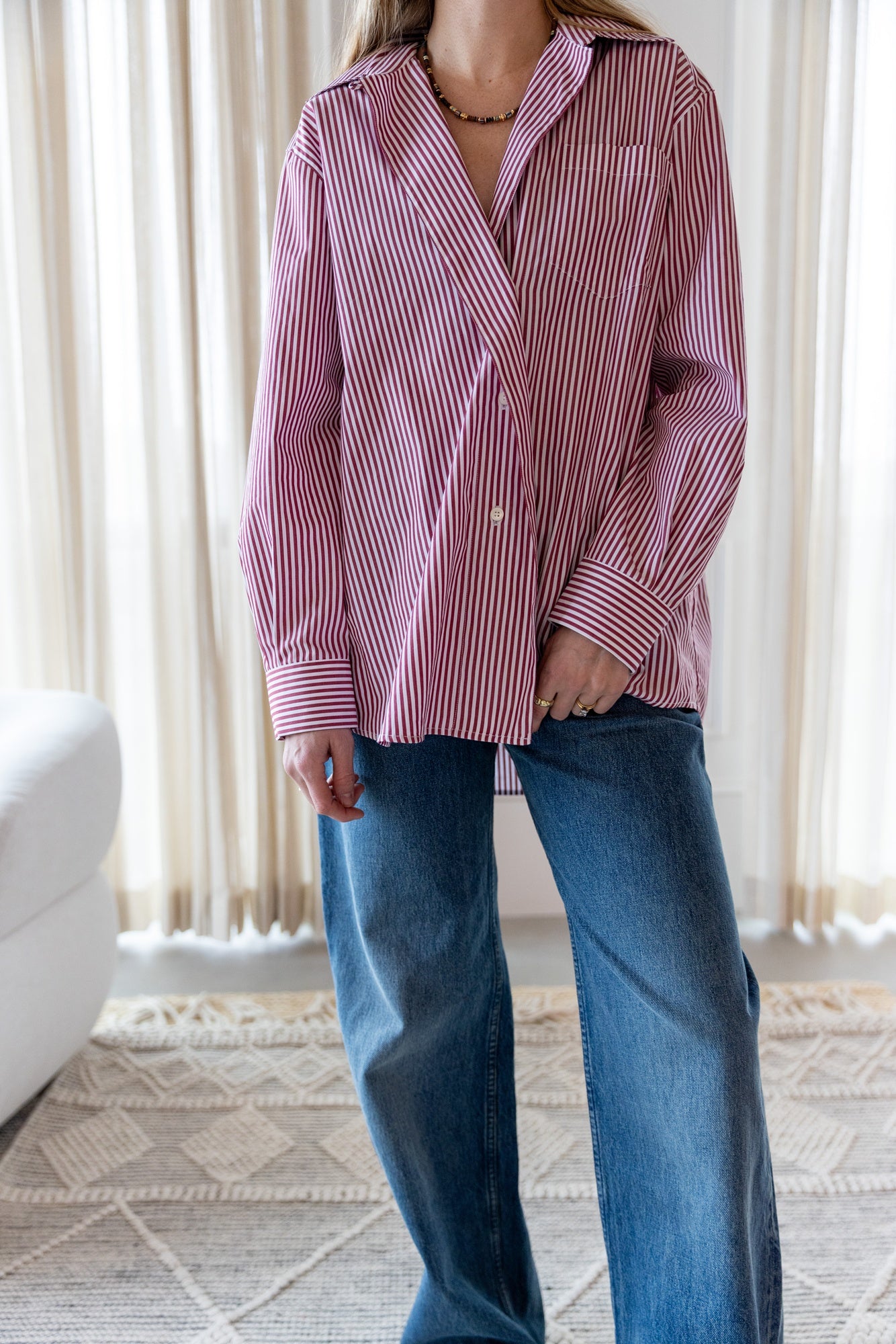 image of a woman wearing the House of Dagmar Asymmetrical Shirt in Red Stripe