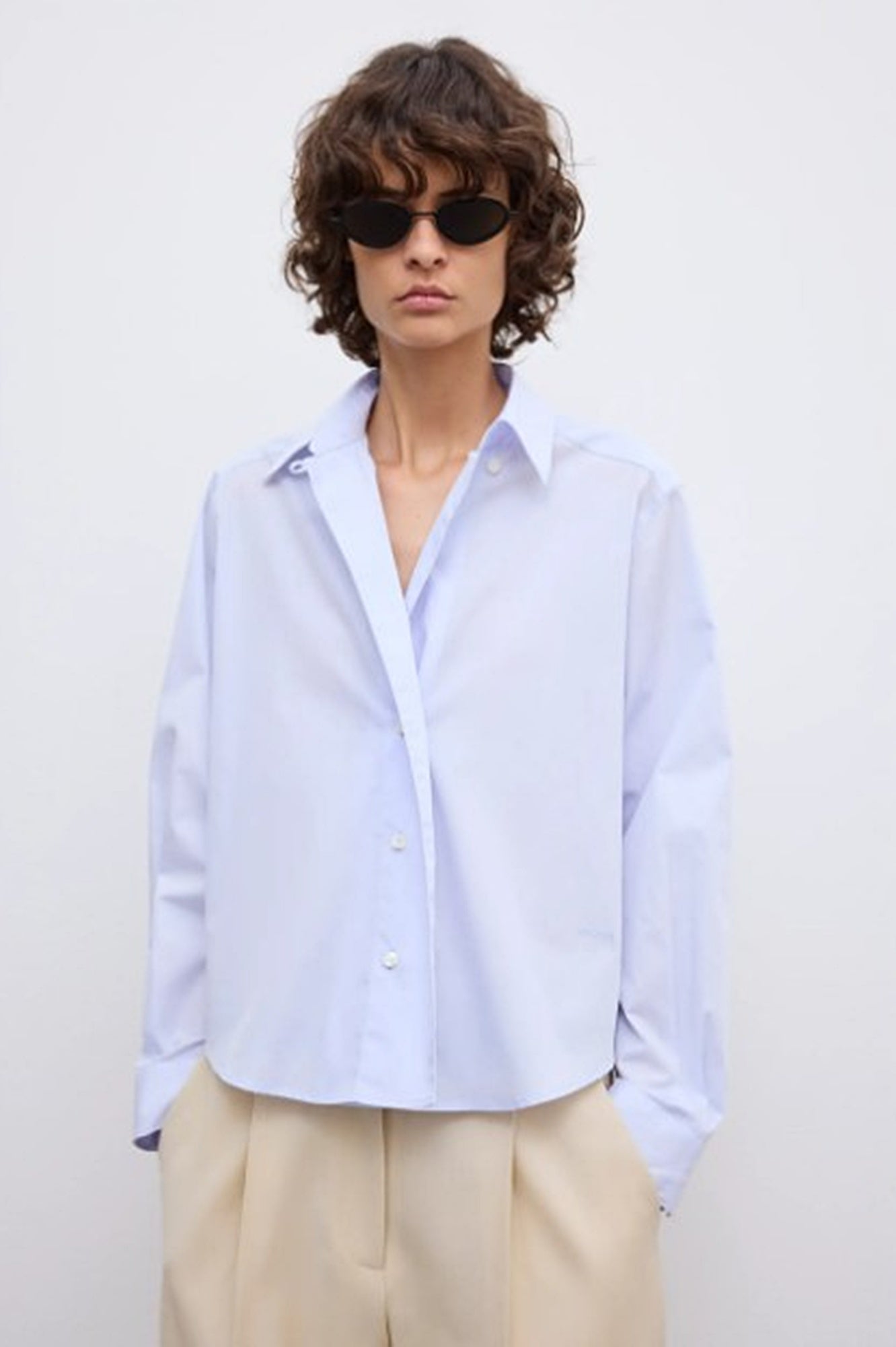 image of a model wearing the House of Dagmar cropped shirt in light blue